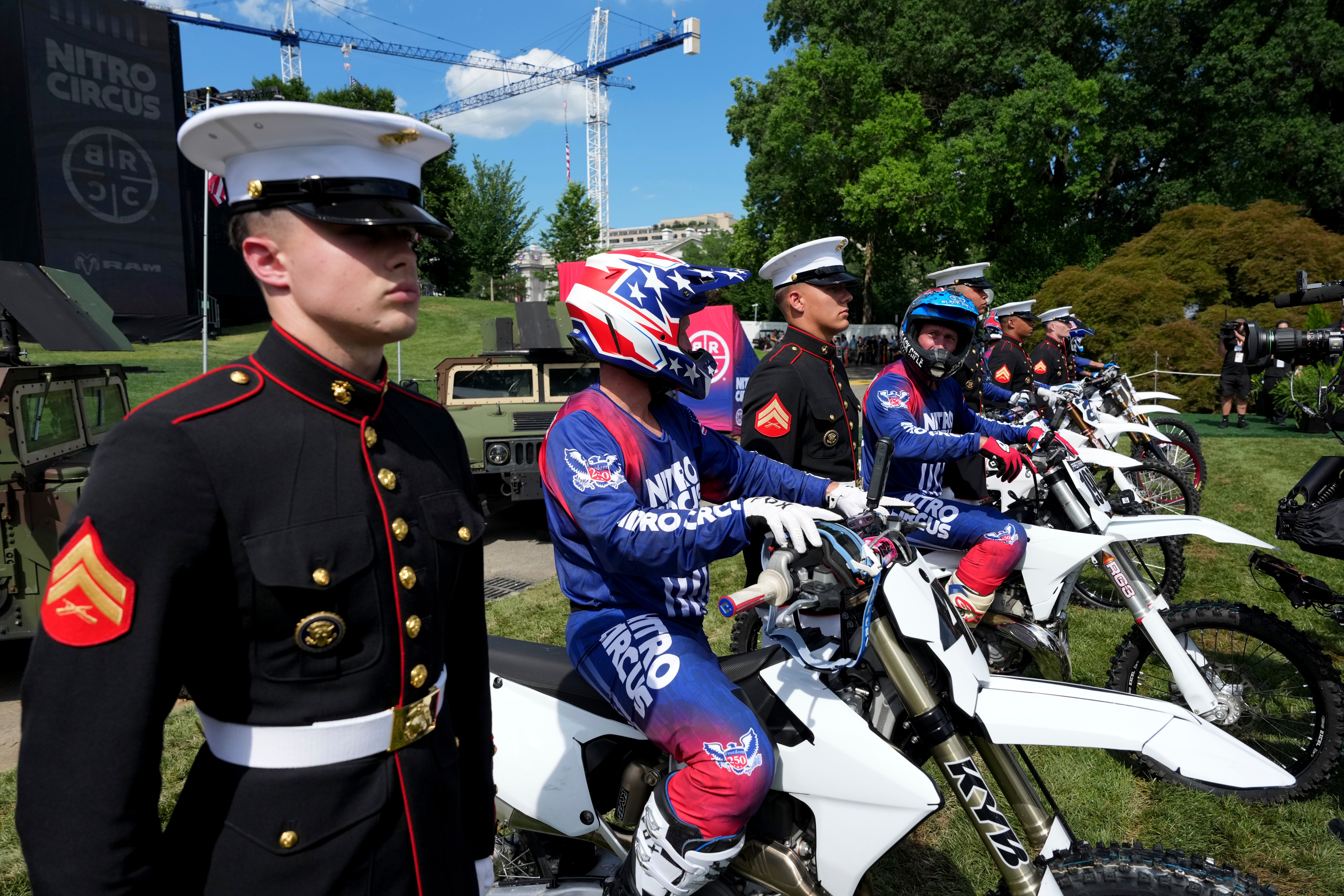 Motorsports athletes and stunt performers line up alongside members of the military after doing a motorcycle jump ahead of the UFC Freedom 250 fights on the South Lawn of the White House, Saturday, June 13, 2026, in Washington. (AP Photo/Alex Brandon, Pool)