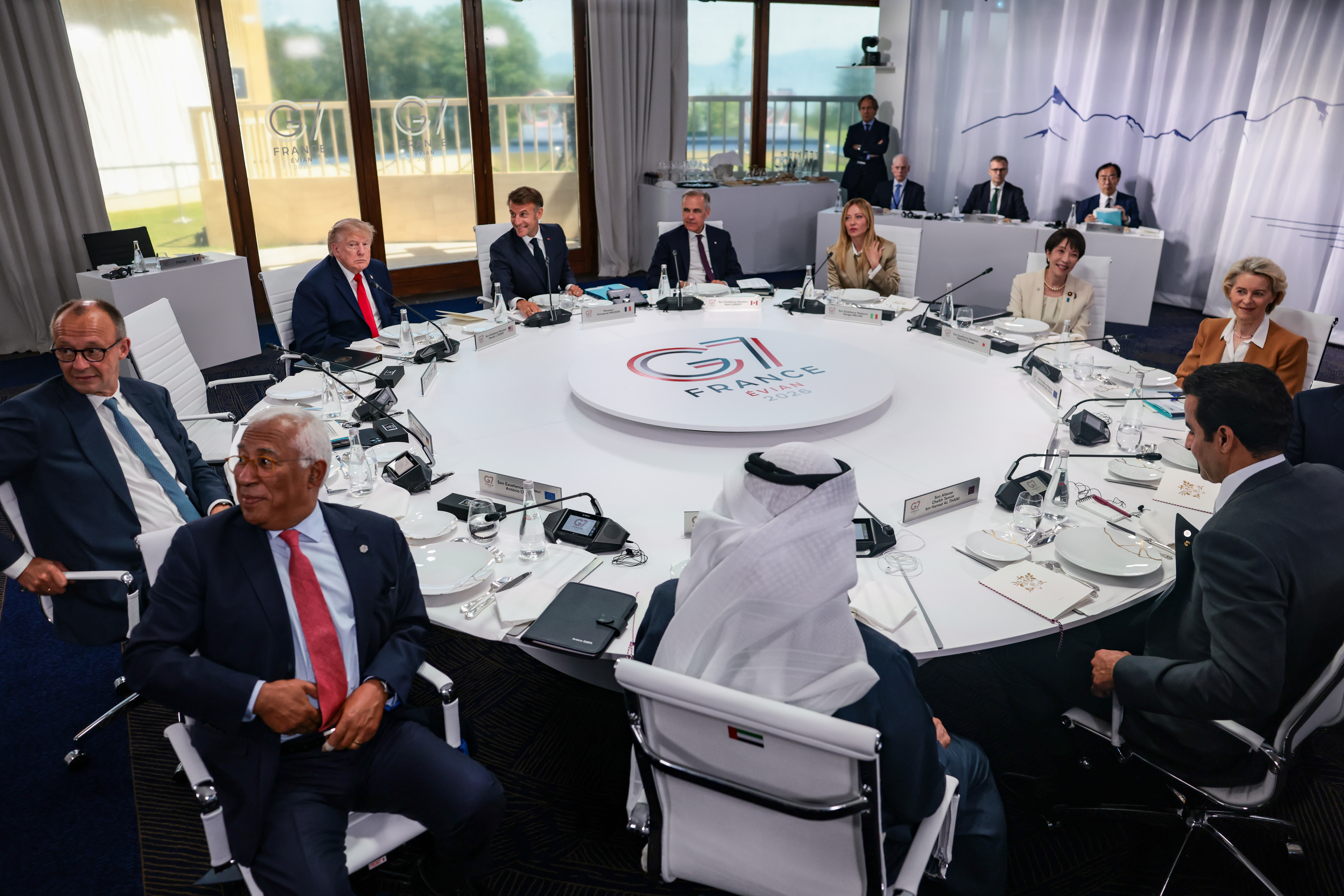 Clockwise rear from left, U.S. President Donald Trump, French President Emmanuel Macron, Canadian Prime Minister Mark Carney, Italian Prime Minister Giorgia Meloni, Japanese Prime Minister Sanae Takaichi, European Commission President Ursula von der Leyen, Qatar Emir Sheikh Tamim bin Hamad Al Thani, President of the United Arab Emirates (UAE) Sheikh Mohamed bin Zayed Al Nahyan, European Council President Antonio Costa, and German Chancellor Friedrich Merz take part in a working lunch with leaders of G7 and the Middle East, in Evian-les-Bains, France, Tuesday, June 16, 2026. (Evelyn Hockstein/Pool Photo via AP)