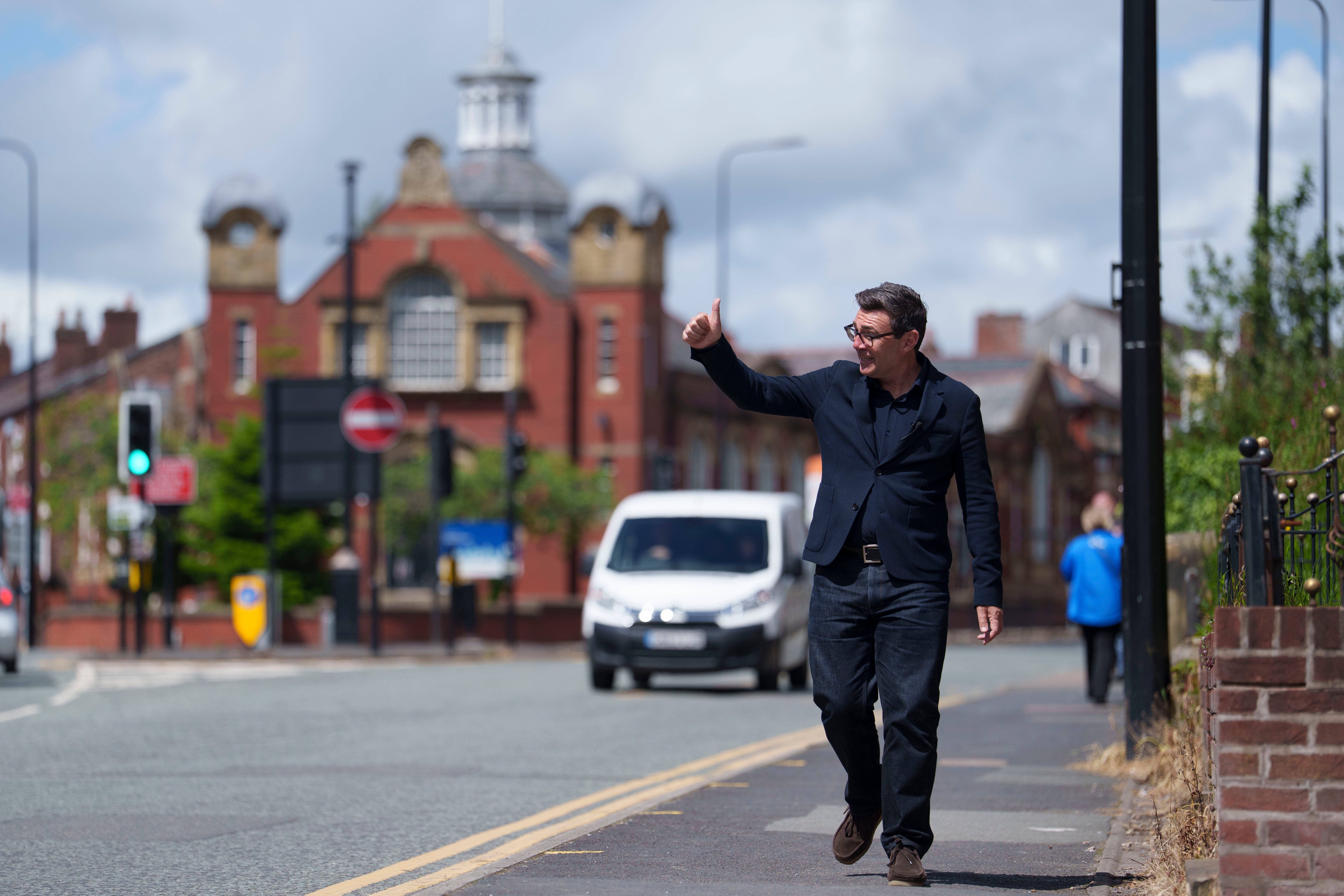 Andy Burnham gives a thumbs up to supporters during a campaign visit to Ashton-in-Makerfield before the forthcoming by-election, in Manchester, England, Tuesday, June 9, 2026. CORRECTION: corrects family name to Burnham instead of Bunham (AP Photo/Jon Super)