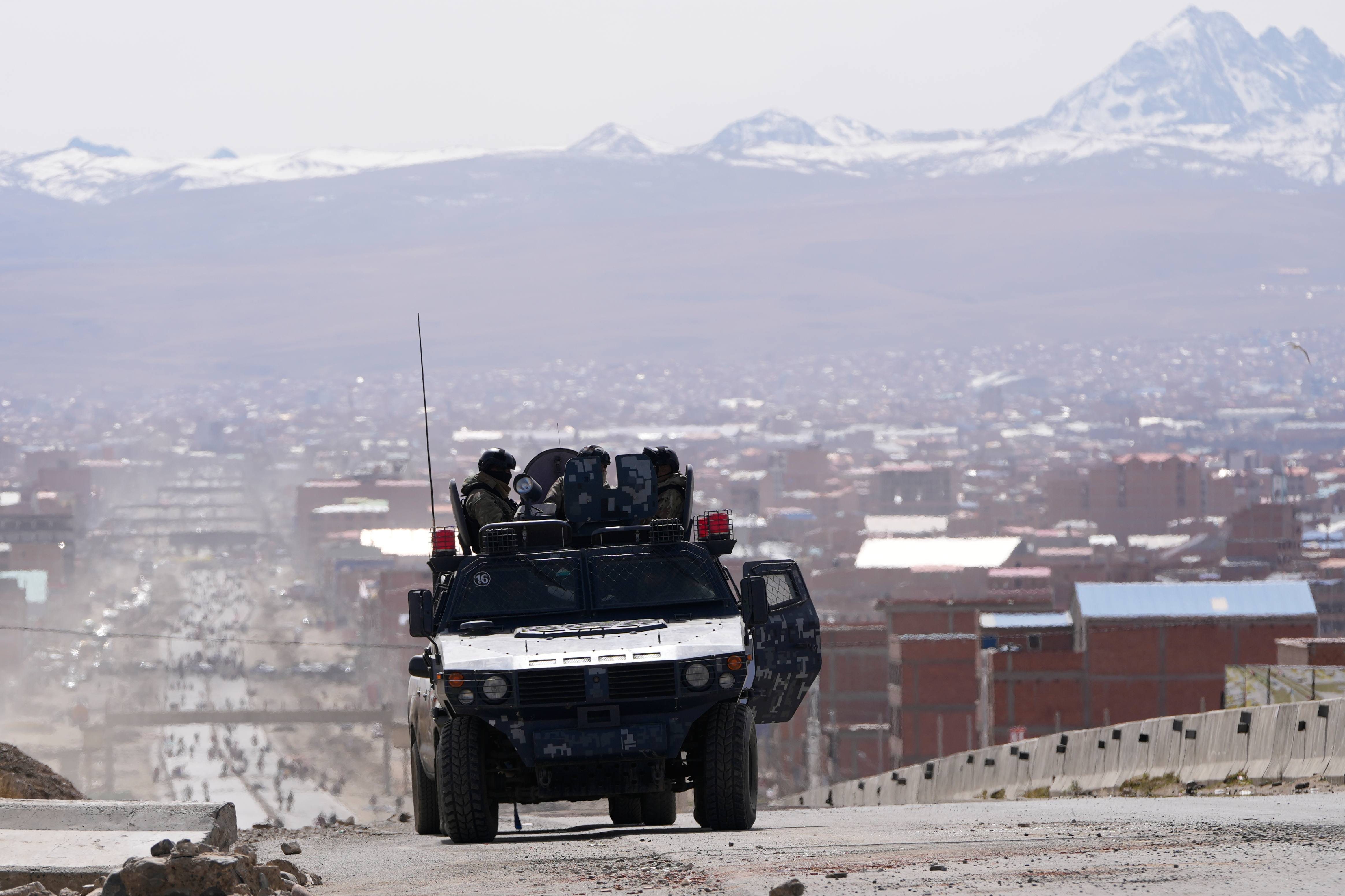 Police patrol a highway after President Rodrigo Paz declared a state of emergency to empower the military to remove road blockades, in El Alto, Bolivia, Saturday, June 20, 2026. (AP Photo/Juan Karita)