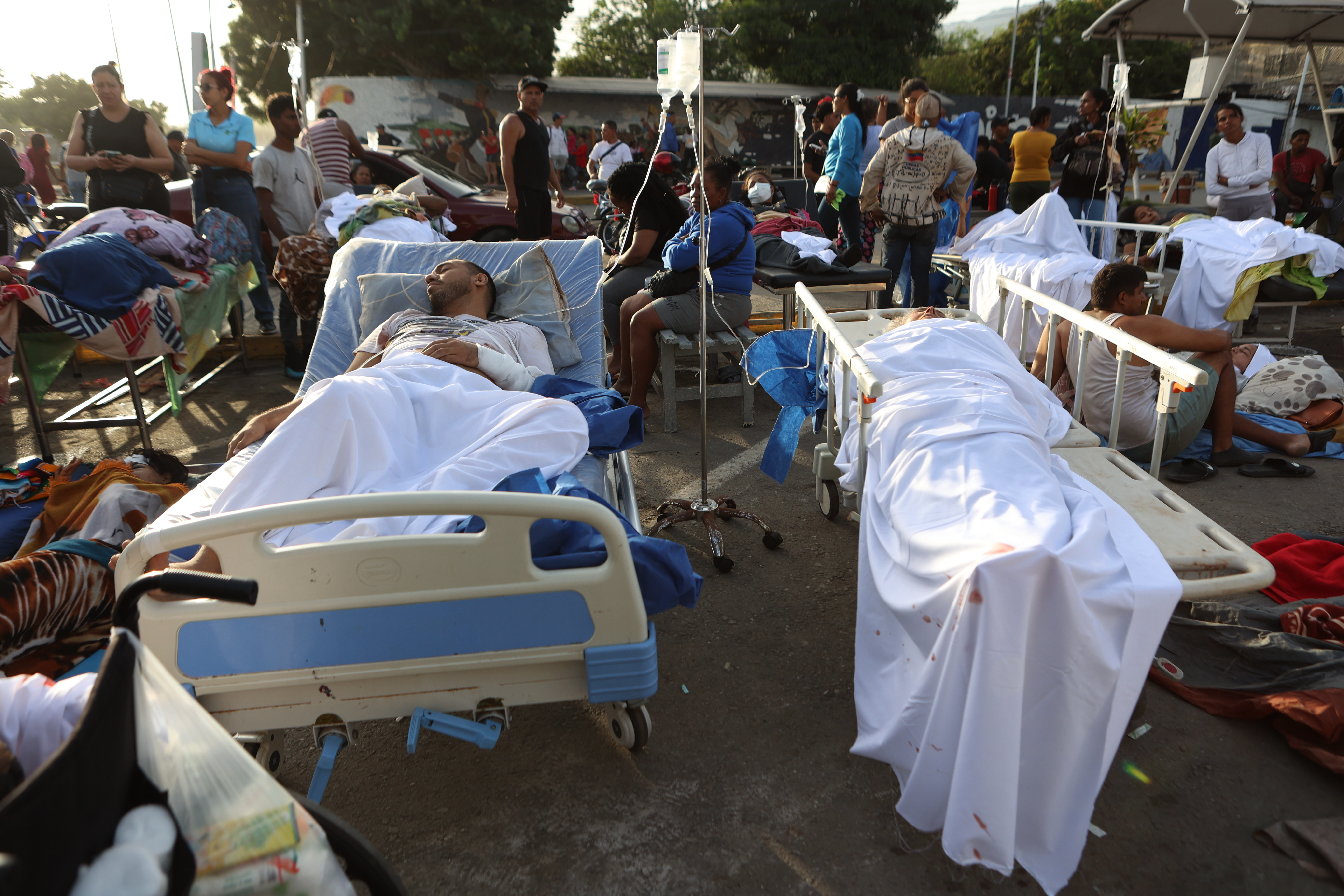 Patients lie outside a hospital evacuated after it was damaged in an earthquake in Catia La Mar, Venezuela, Thursday, June 25, 2026. (AP Photo/Pedro Mattey)
