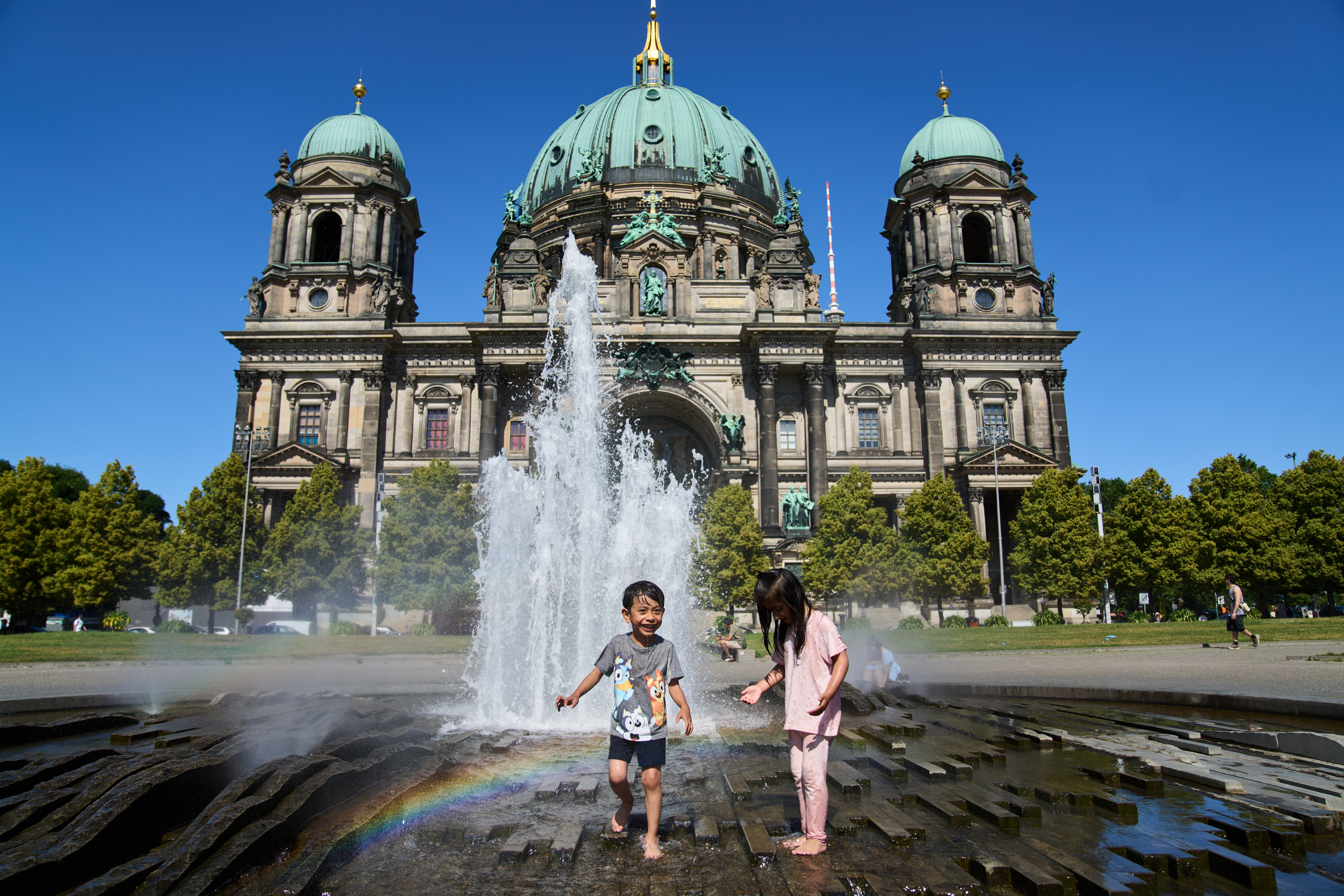 Children cool off in a fountain.