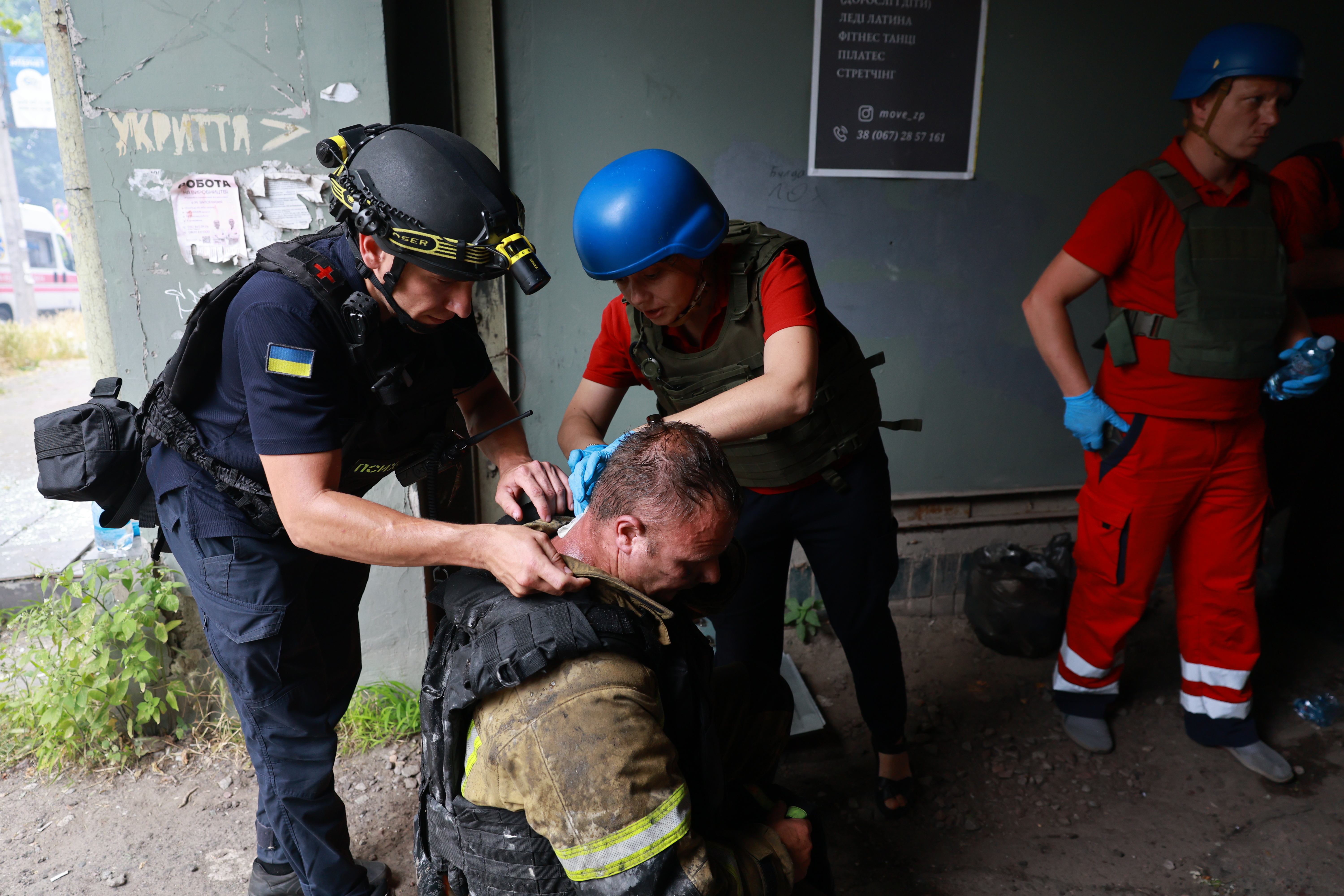 Rescue workers provide medical help to an injured man.