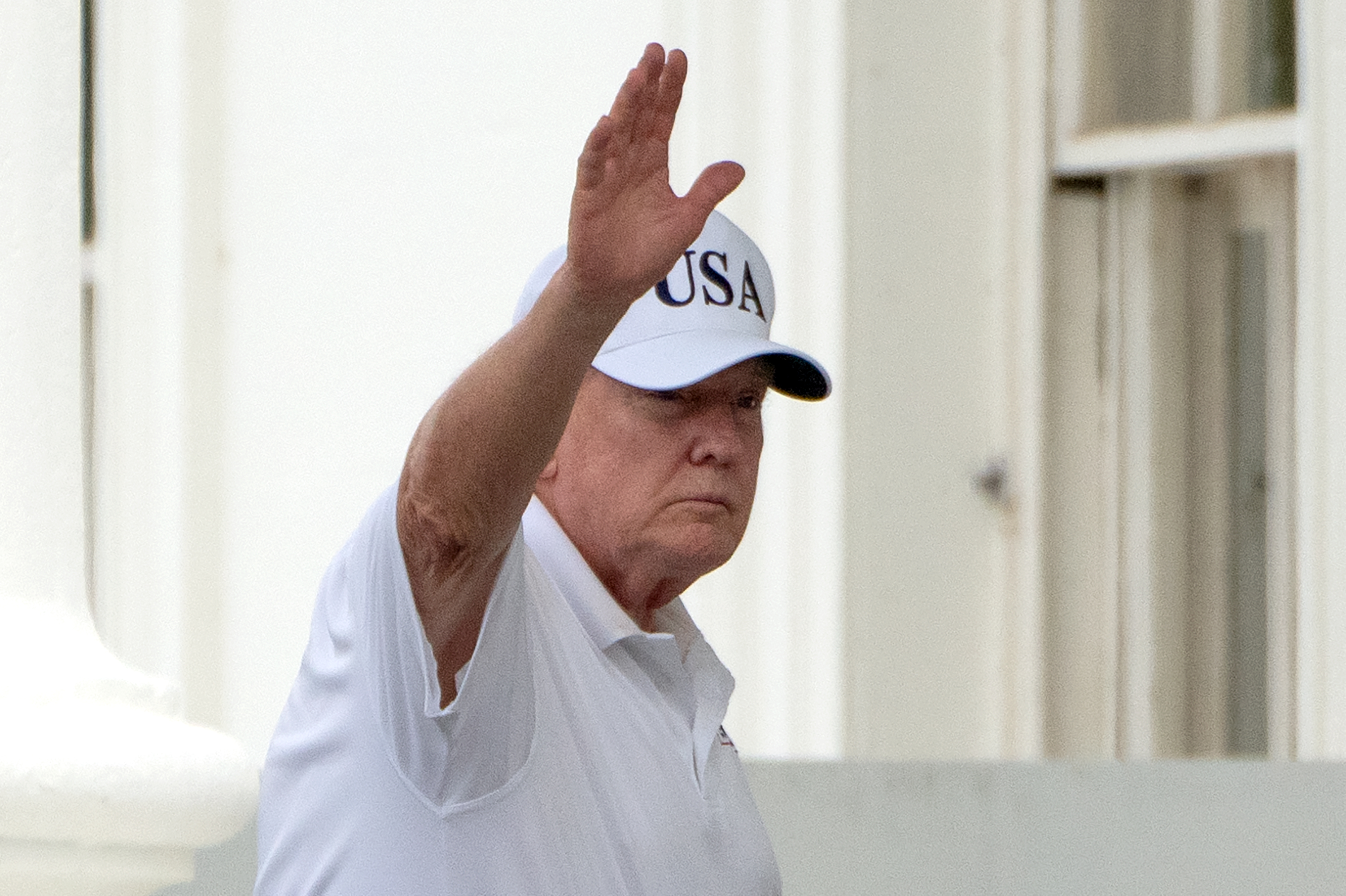 President Donald Trump waves as he walks into the North Portico at the White House, Saturday, June 27, 2026, in Washington. (AP Photo/Mark Schiefelbein)