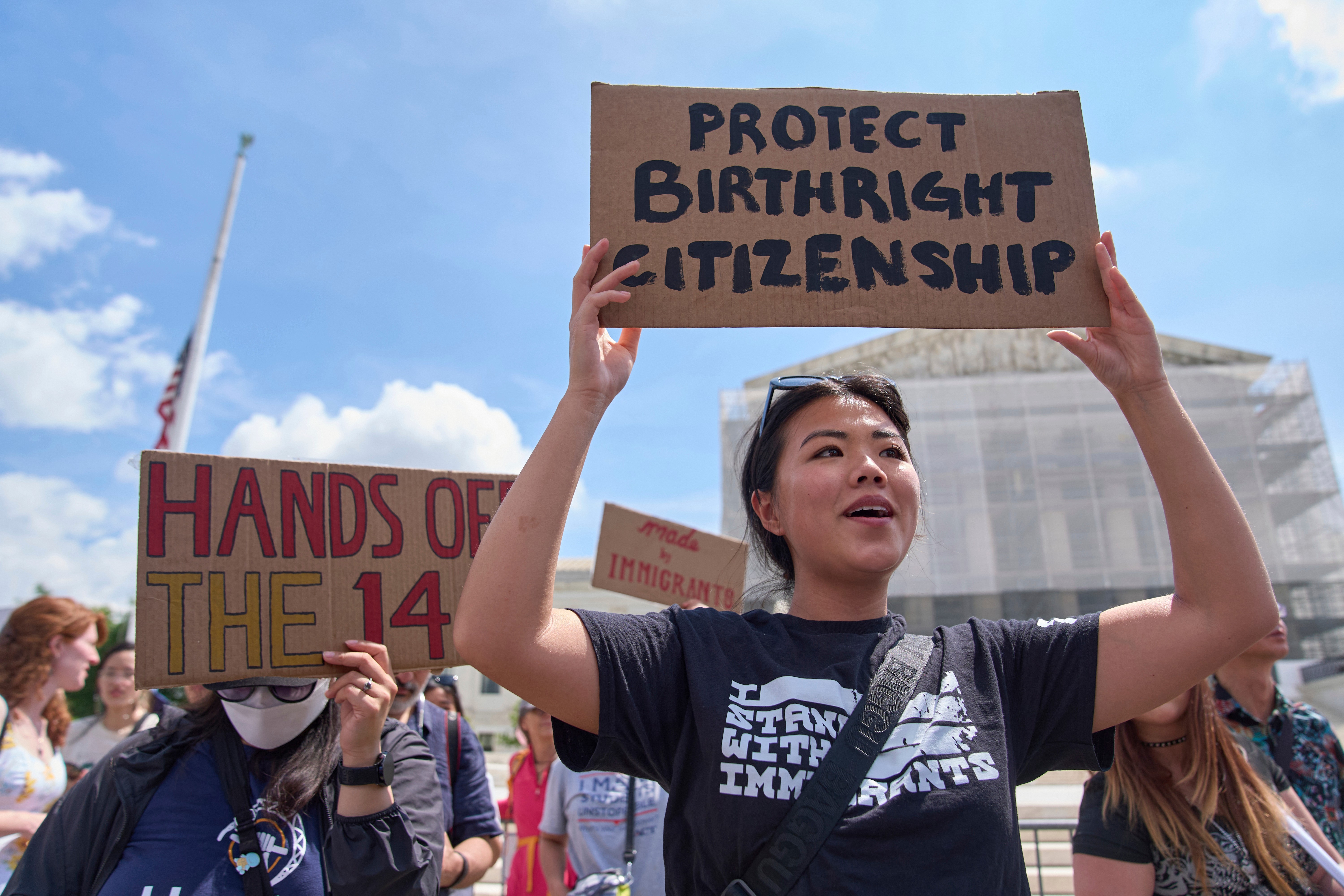 FILE - Hannah Liu, 26, of Washington, holds up a sign in support of birthright citizenship, May 15, 2025, outside of the Supreme Court in Washington. (AP Photo/Jacquelyn Martin, File)