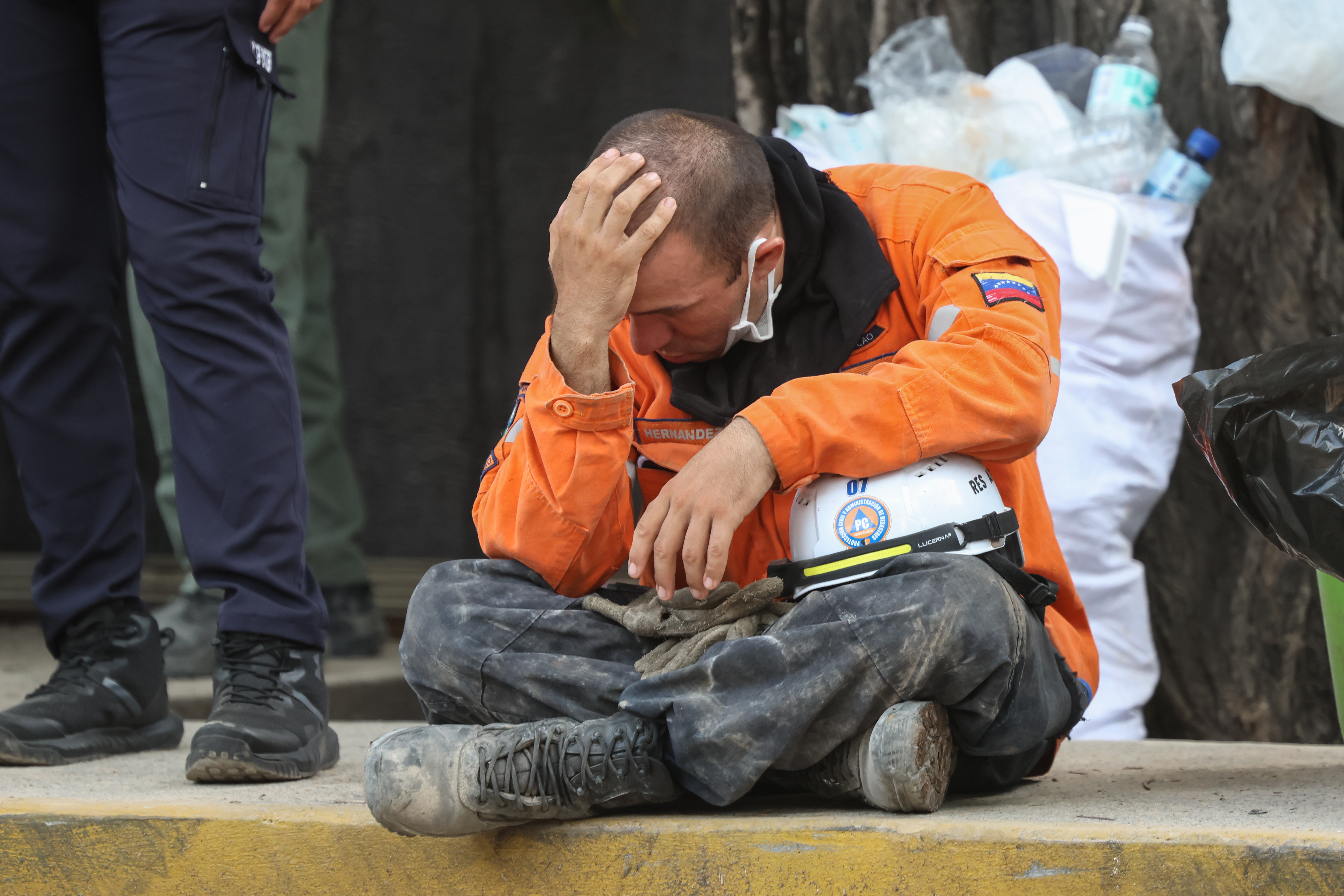 CARACAS, VENEZUELA - JUNE 25: A Civil Protection worker sits after a magnitude 7.2 earthquake struck Venezuela and other regions in the Caribbean on June 25, 2026 in Caracas, Venezuela. According to the U.S. Geological Survey (USGS), the main earthquake was followed by a 7.5-magnitude aftershock less than a minute later. The number of victims increased to 164 and over a thousand injured. (Photo by Edilzon Gamez/Getty Images)
