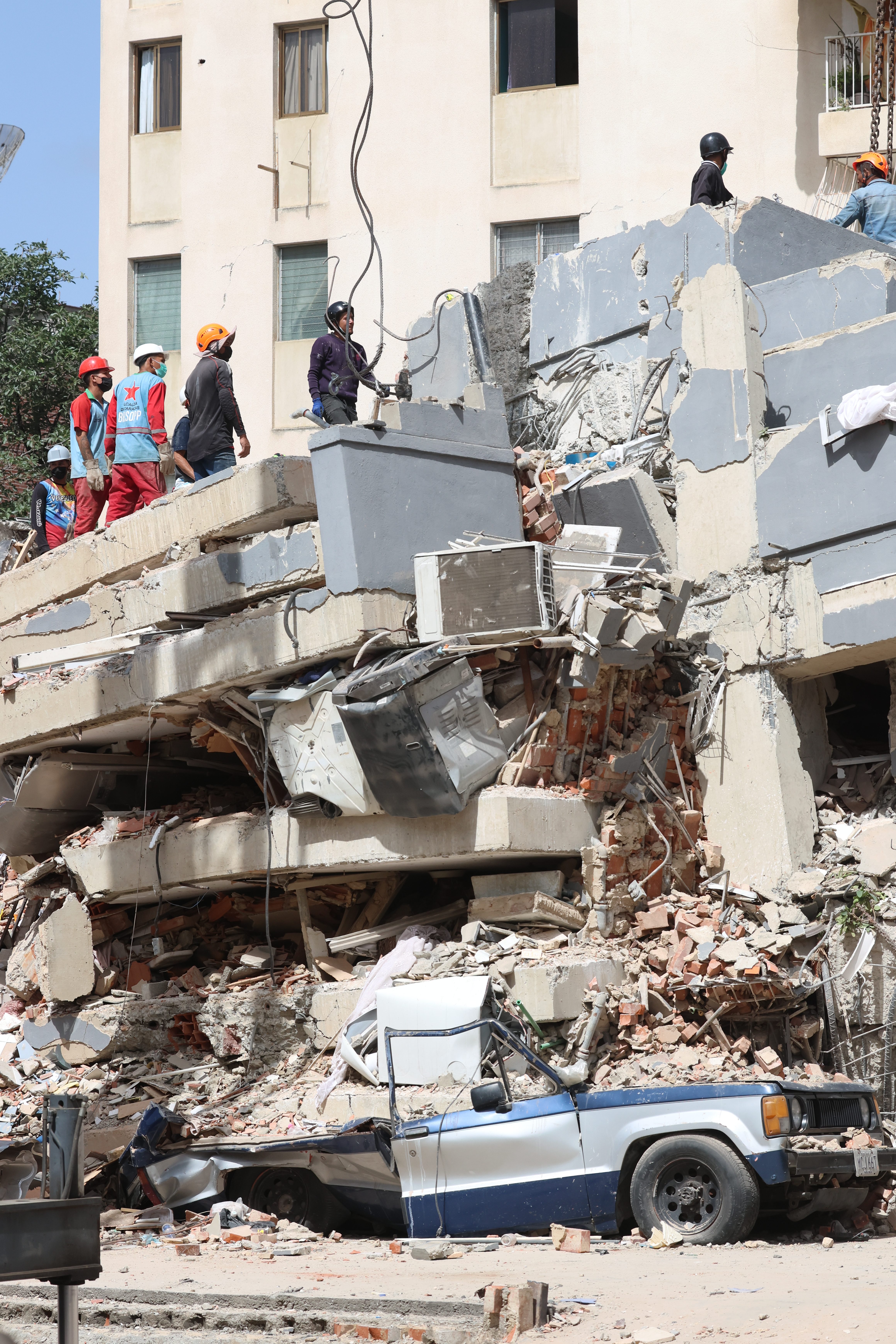 CARACAS, VENEZUELA - JUNE 26: Rescuers work on the debris of San Judas Tadeo collapsed building as rescue efforts continue at El Paraiso after a magnitude 7.2 earthquake struck Venezuela and other regions in the Caribbean on June 26, 2026 in Caracas, Venezuela. According to the U.S. Geological Survey (USGS), the main earthquake was followed by a 7.5-magnitude aftershock less than a minute later. The number of victims increased to more than 500, and around 3,000 injured. A web page created to find people has registered almost 50,000 missing people. (Photo by Edilzon Gamez/Getty Images)