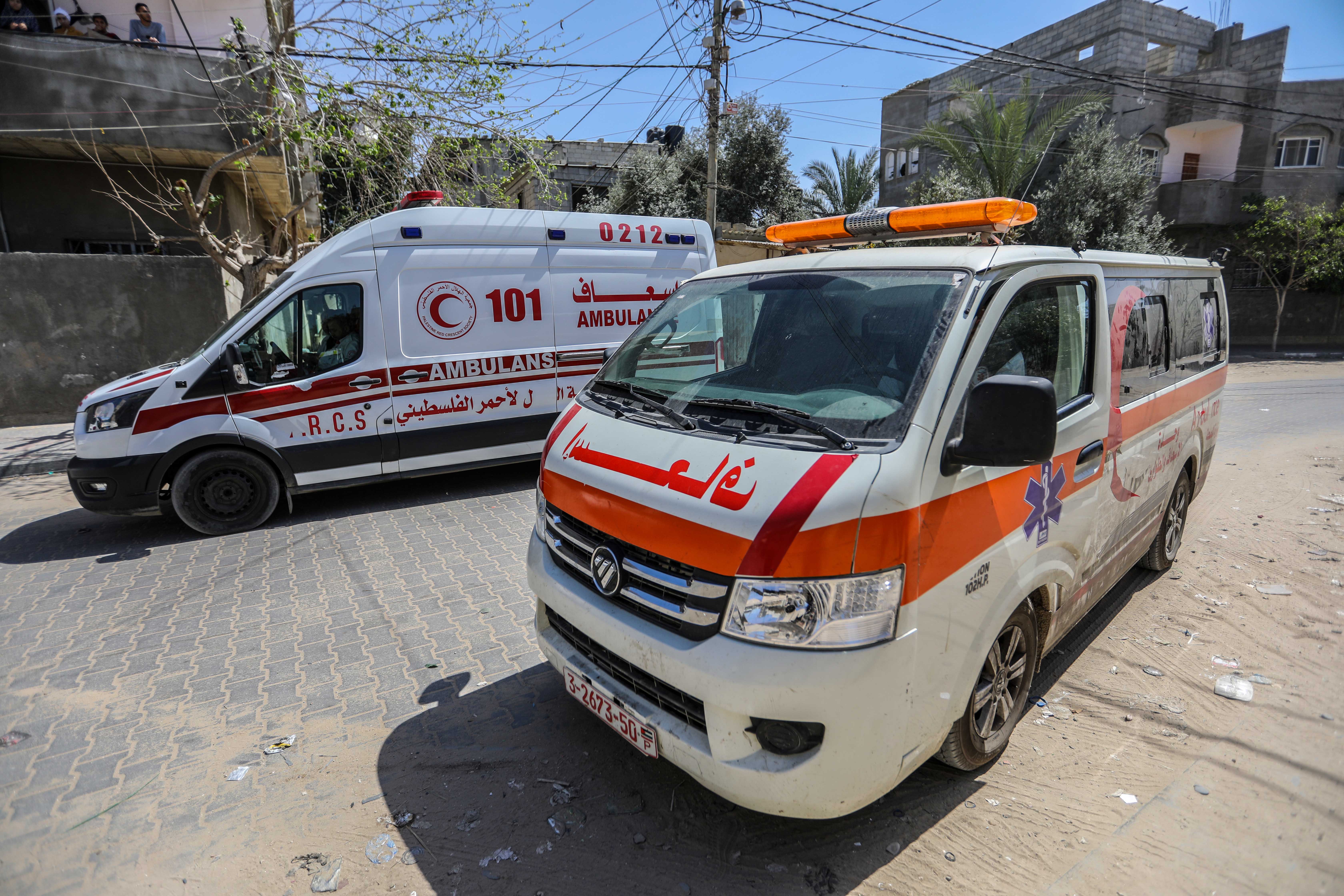 RAFAH, GAZA - APRIL 03: Medics prepare the bodies of World Central Kitchen workers, who were killed in Israeli air strikes, for their return to their home counties on April 03, 2024 in Rafah, Gaza. In a statement, the charity World Central Kitchen said that seven of its workers were killed by an Israeli air strike while driving in a convoy after leaving a warehouse in Deir al-Balah, in central Gaza. Israel issued a rare apology over the incident, calling their deaths a "grave mistake." The killed workers included both Palestinians and foreigners.(Photo by Ahmad Hasaballah/Getty Images)