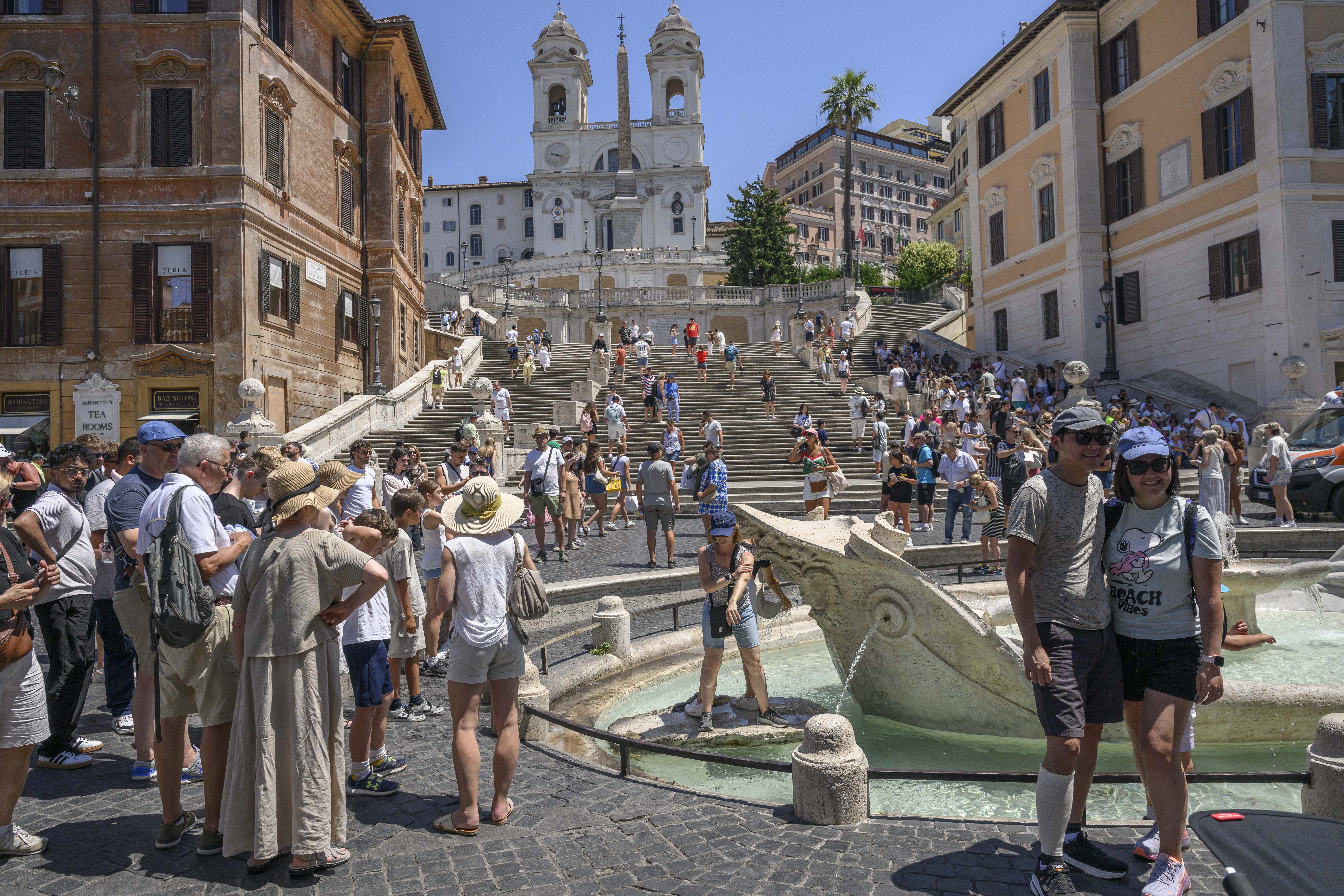 ROME, ITALY - JULY 1: People cool off in the Barcaccia fountain during an ongoing heatwave with temperatures reaching 40 degrees, at Piazza di Spagna, on July 1, 2025 in Rome, Italy. Rome is one of 17 regions across Italy that have been issued with a Level 3 heat risk for Tuesday, indicating emergency conditions that post a risk to health. Heatwave conditions are forecast to continue across southern Europe throughout the week. (Photo by Antonio Masiello/Getty Images)