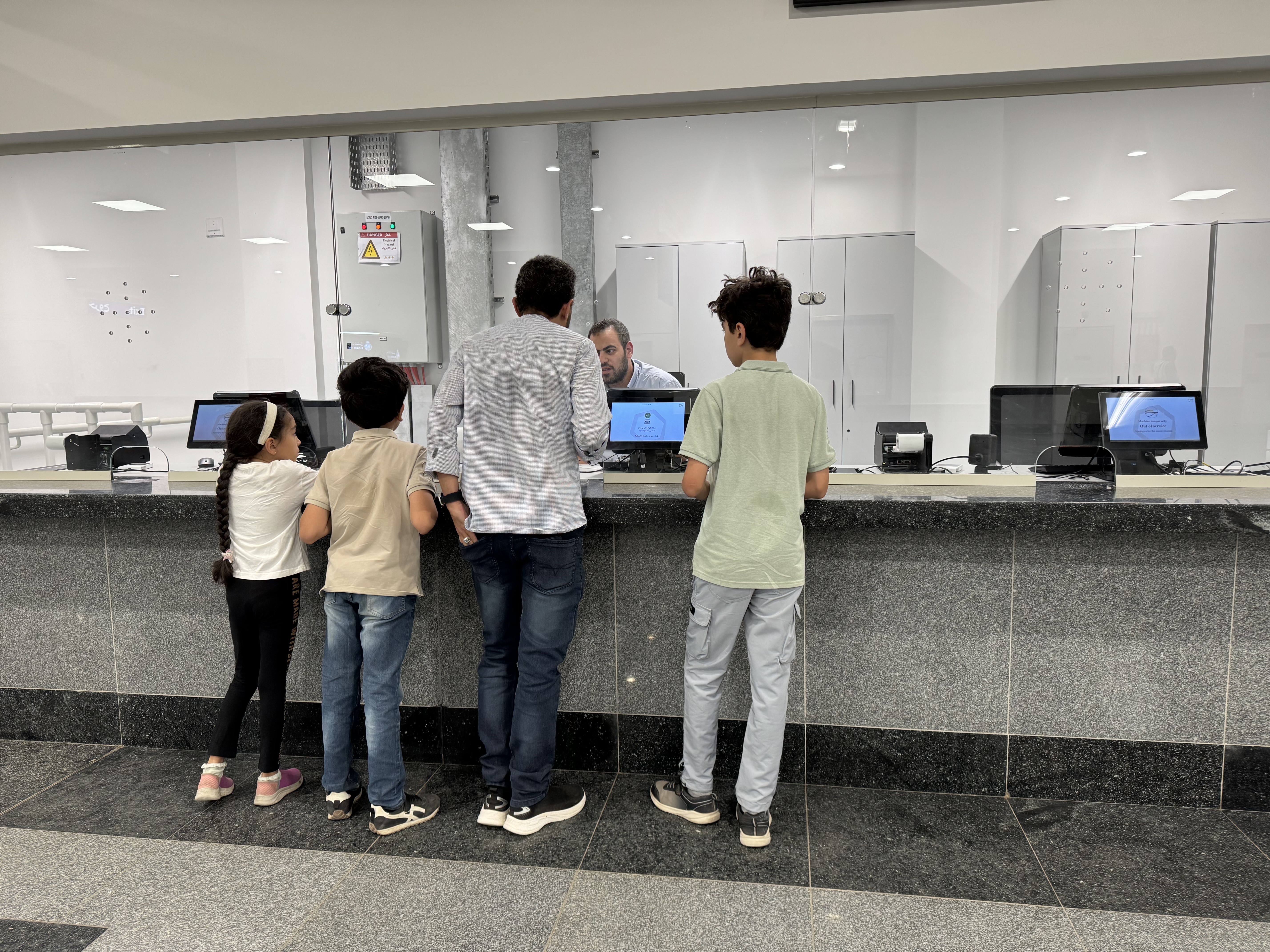 A family checking in to ride the metro. 