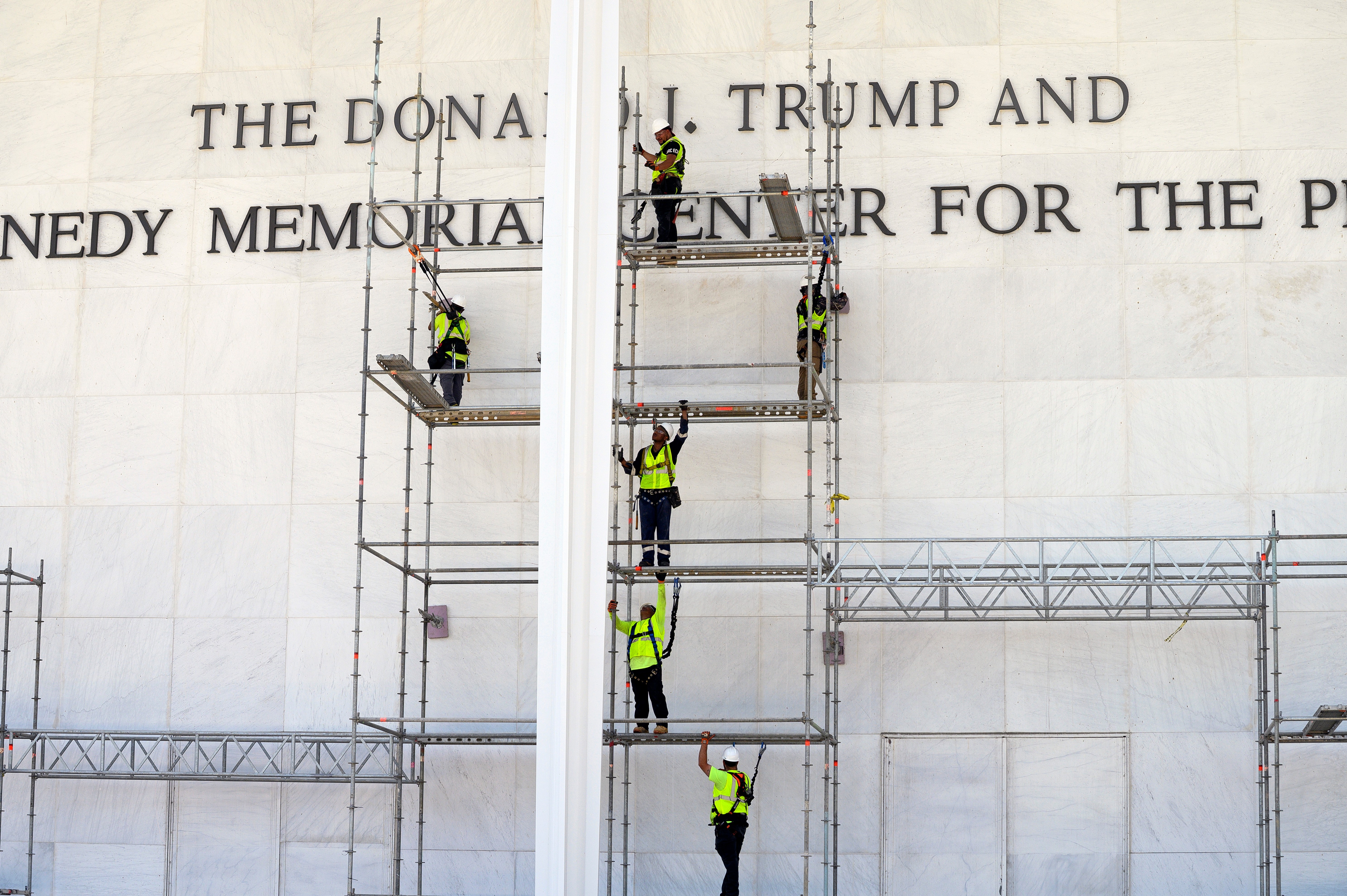 Workers erect scaffolding in front of the John F. Kennedy Center for the Performing Arts sign in Washington, Friday, June 12, 2026. (AP Photo/Cliff Owen)