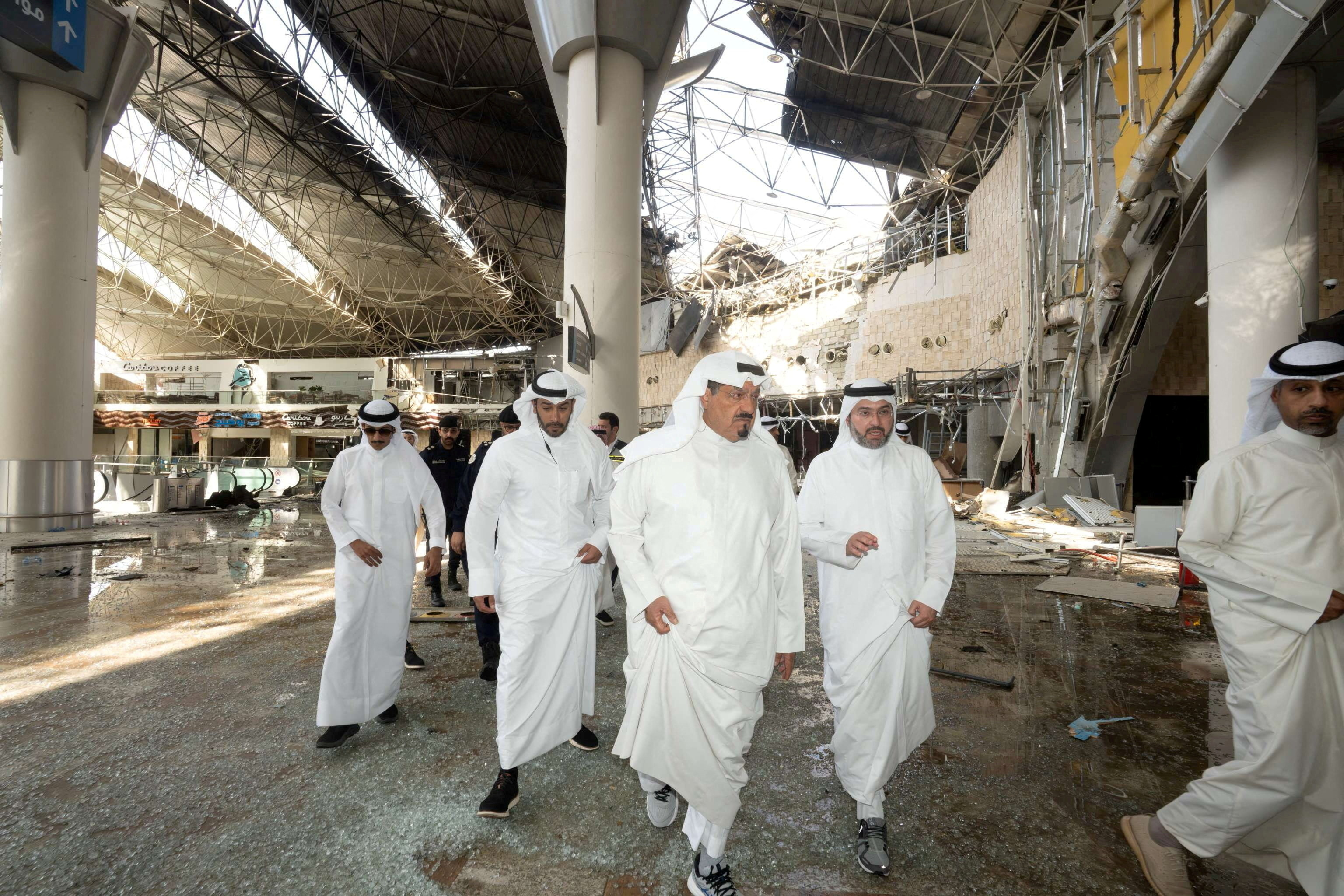 Kuwaiti officials inspect damage inside a terminal at Kuwait International Airport following a drone and missile attack,[reuters]