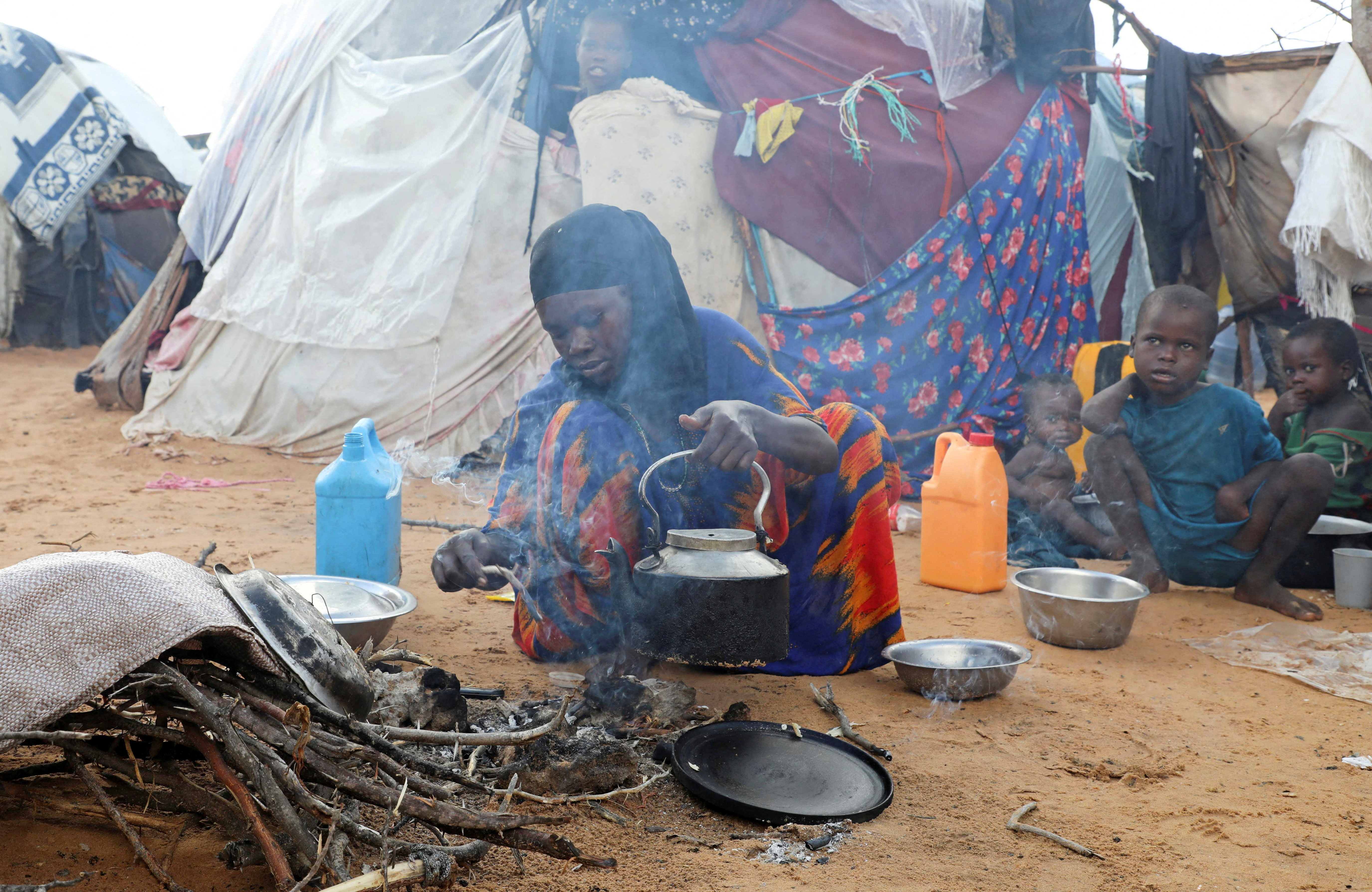 An internally displaced woman prepares food.