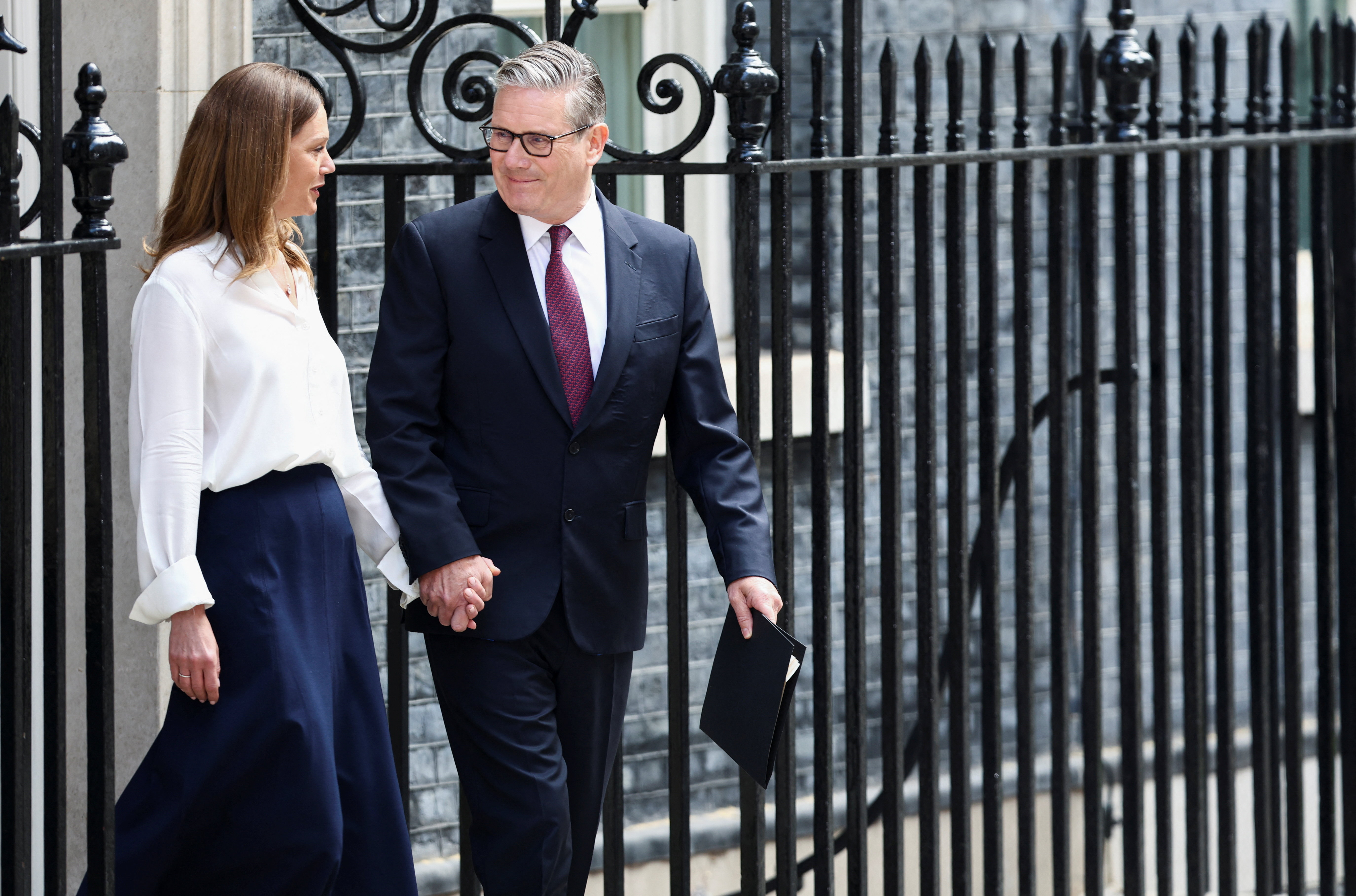 British Prime Minister Keir Starmer walks with his wife Victoria, on the day he announces the timeline for his resignation, outside 10 Downing Street, in London, Britain, June 22, 2026. REUTERS/Toby Shepheard