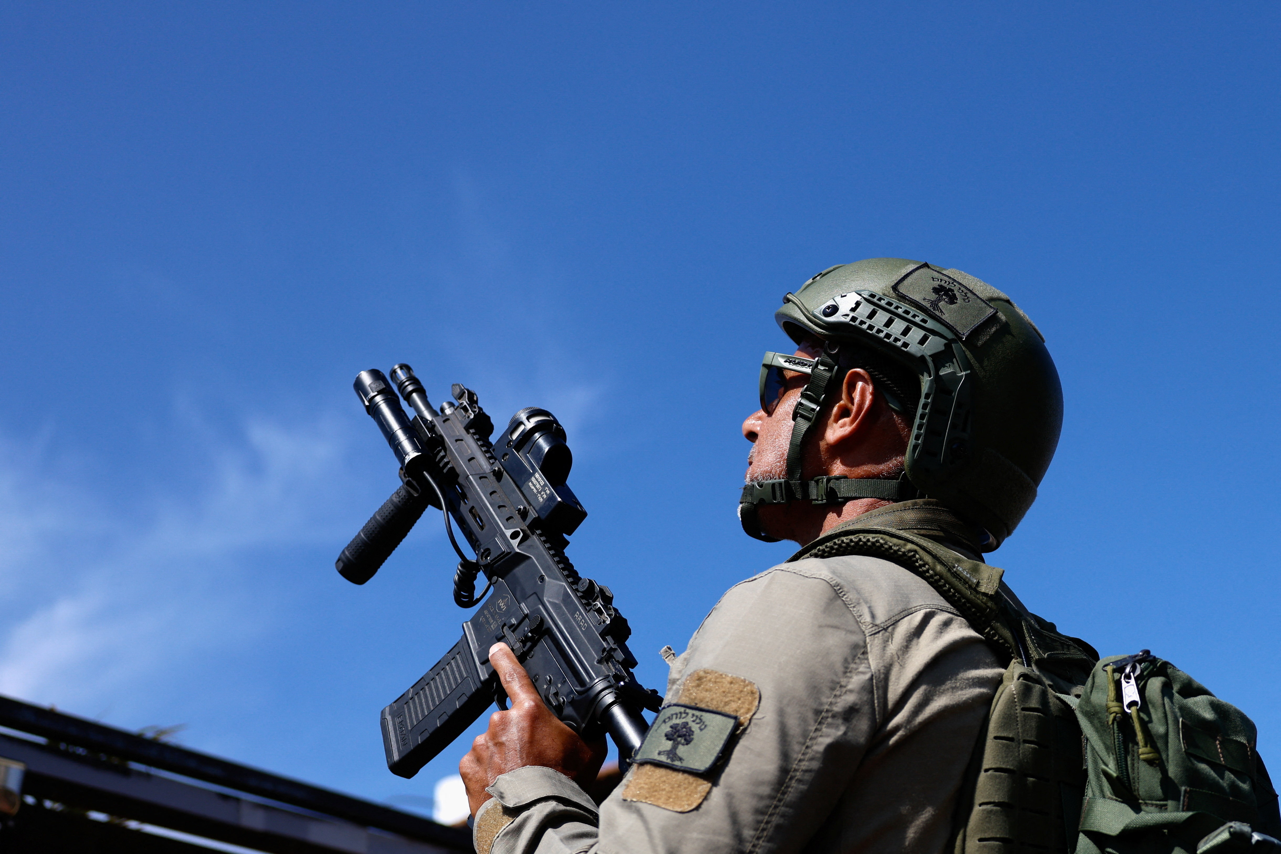 A member of a civilian response team looks at the sky as he searches for a hostile drone, in Metula, on the Israeli side of the Israel-Lebanon border, June 1, 2026. REUTERS/Amir Cohen