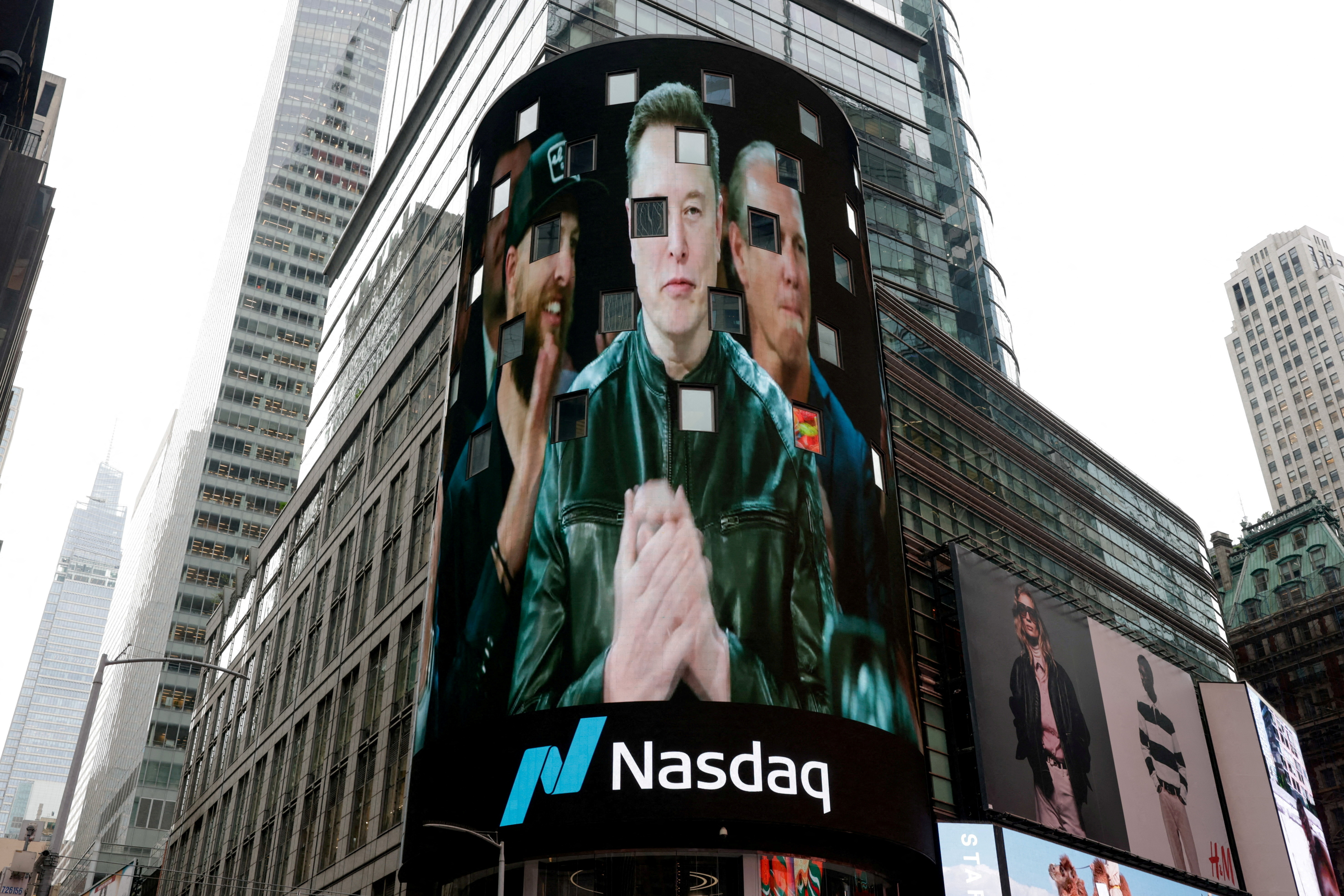 FILE PHOTO: A live feed shows SpaceX CEO Elon Musk on the day of SpaceX's initial public offering (IPO) at the Nasdaq MarketSite, in New York City, U.S., June 12, 2026. REUTERS/Jeenah Moon/File Photo