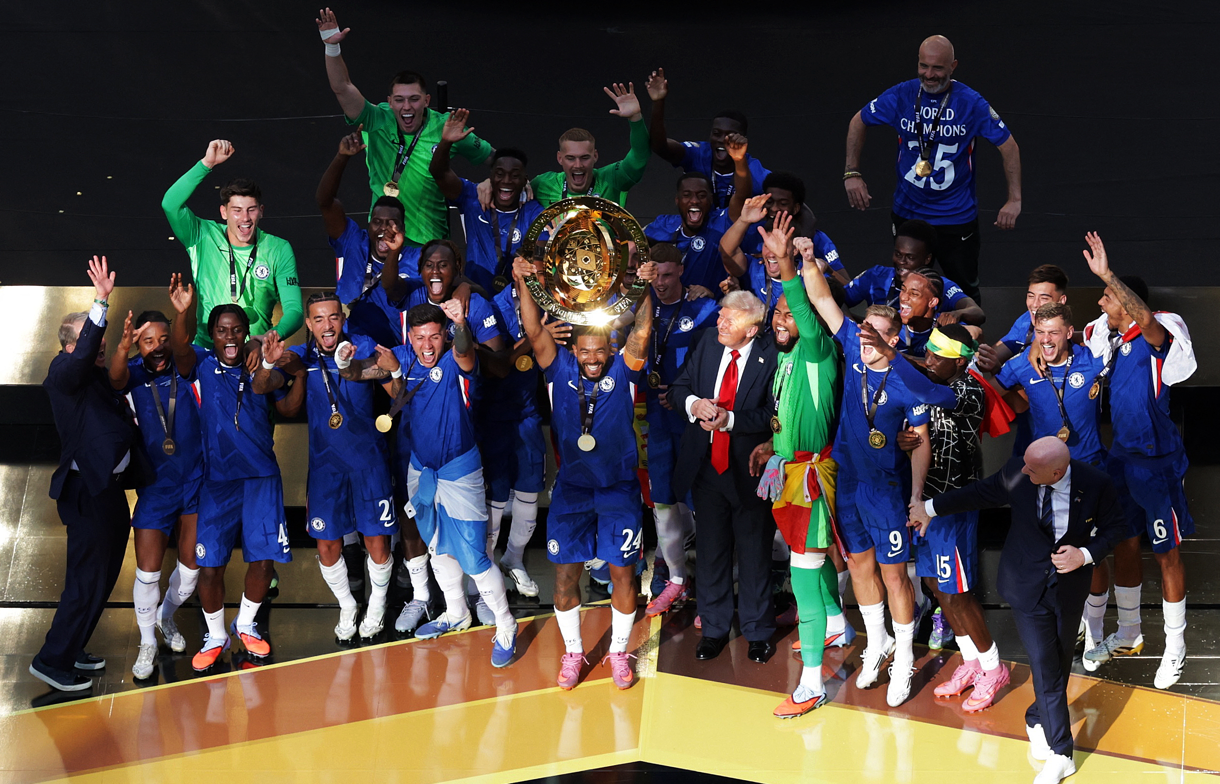 Soccer Football - FIFA Club World Cup - Final - Chelsea v Paris St Germain - MetLife Stadium, East Rutherford, New Jersey, U.S. - July 13, 2025 Chelsea's Reece James lifts the trophy as he celebrates with teammates after winning the FIFA Club World Cup as U.S. President Donald Trump and FIFA president Gianni Infantino look on REUTERS/Jeenah Moon