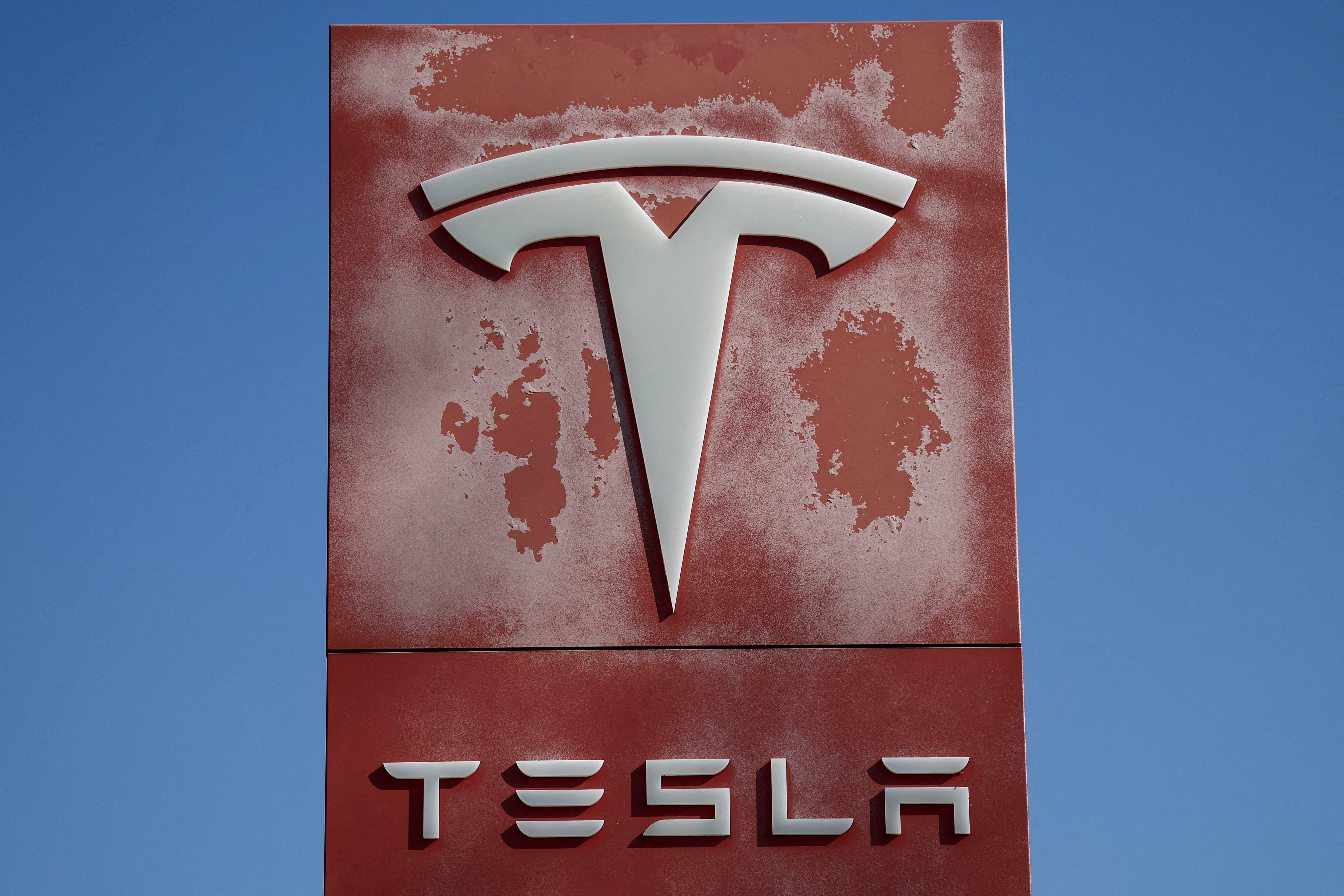 FILE PHOTO: The logo of Tesla is pictured at a dealership in Saint-Herblain near Nantes, France, March 27, 2025. REUTERS/Stephane Mahe/File Photo