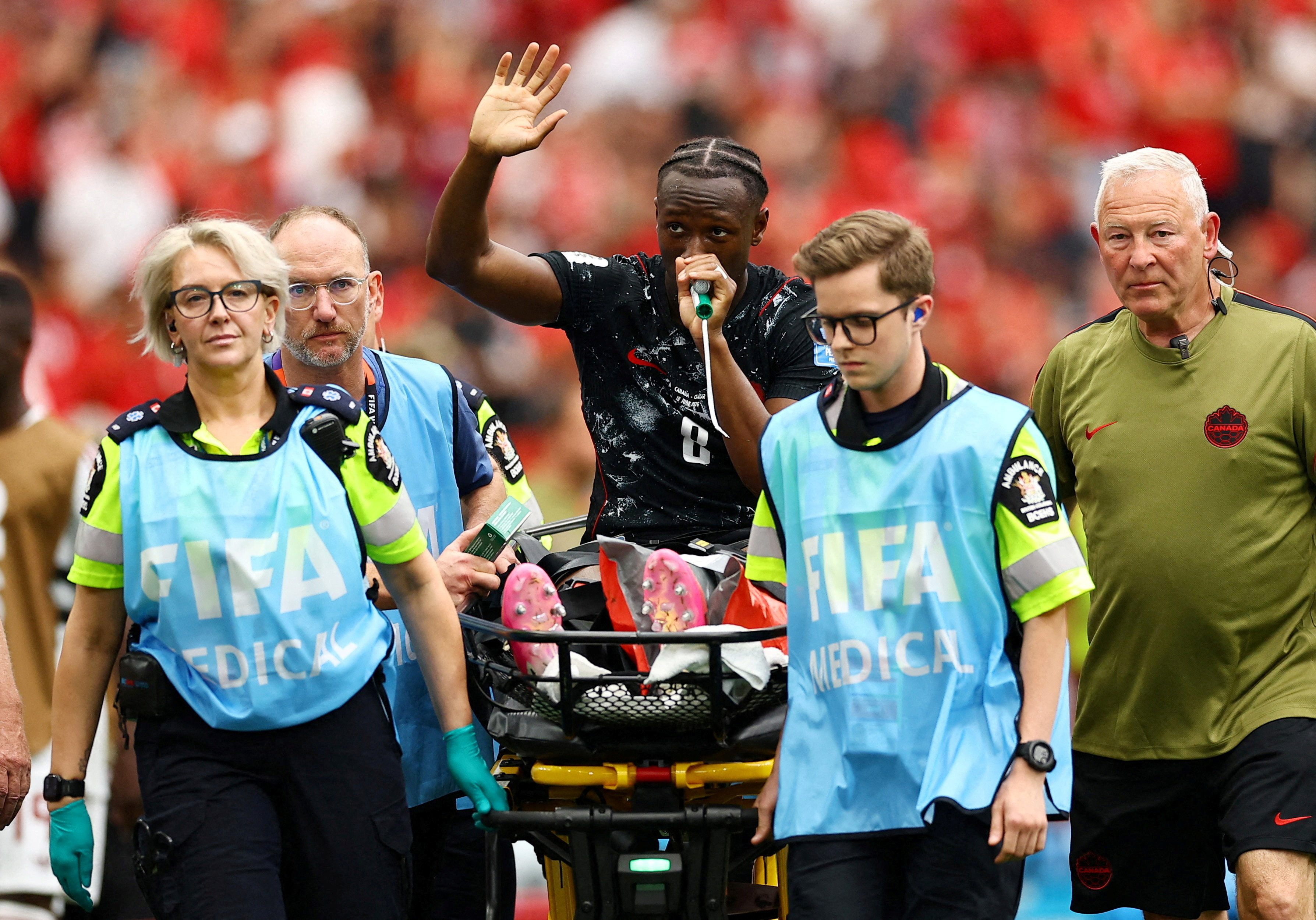 Soccer Football - FIFA World Cup 2026 - Group B - Canada v Qatar - BC Place, Vancouver, Canada - June 18, 2026. Canada's Ismael Kone waves to the crowd as he uses a "green whistle" (Penthrox), a portable, self-administered inhaler used by paramedics for fast-acting pain relief, after sustaining an injury and being stretchered off. REUTERS/Agustin Marcarian TPX IMAGES OF THE DAY REFILE - CORRECTING INFO FROM "RECEIVES OXYGEN" TO "USES "GREEN WHISTLE" (PENTHROX), A PORTABLE, SELF-ADMINISTERED INHALER USED BY PARAMEDICS FOR FAST-ACTING PAIN RELIEF
