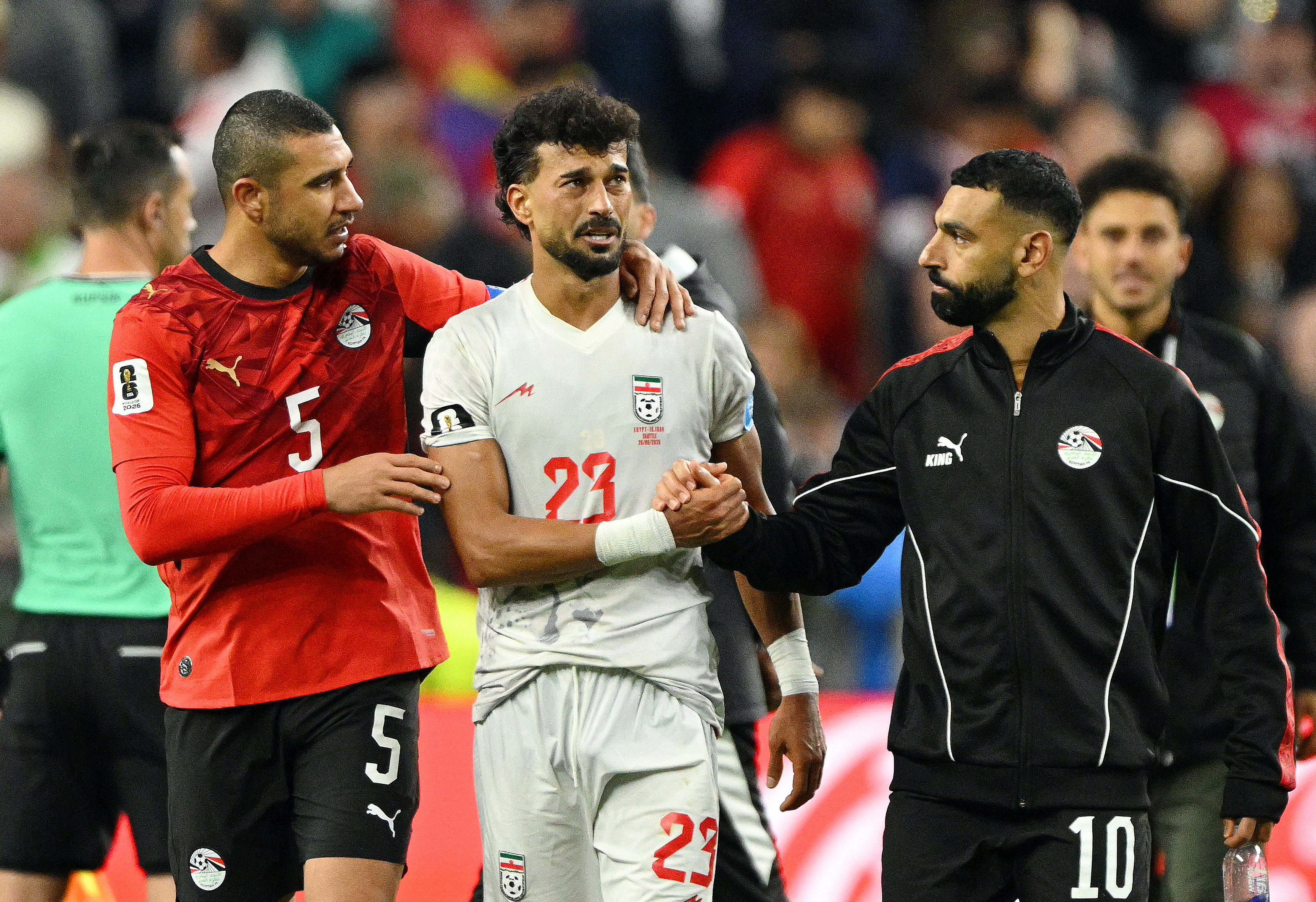 Egypt's Mohamed Salah shakes hands with Iran's Ramin Rezaeian.