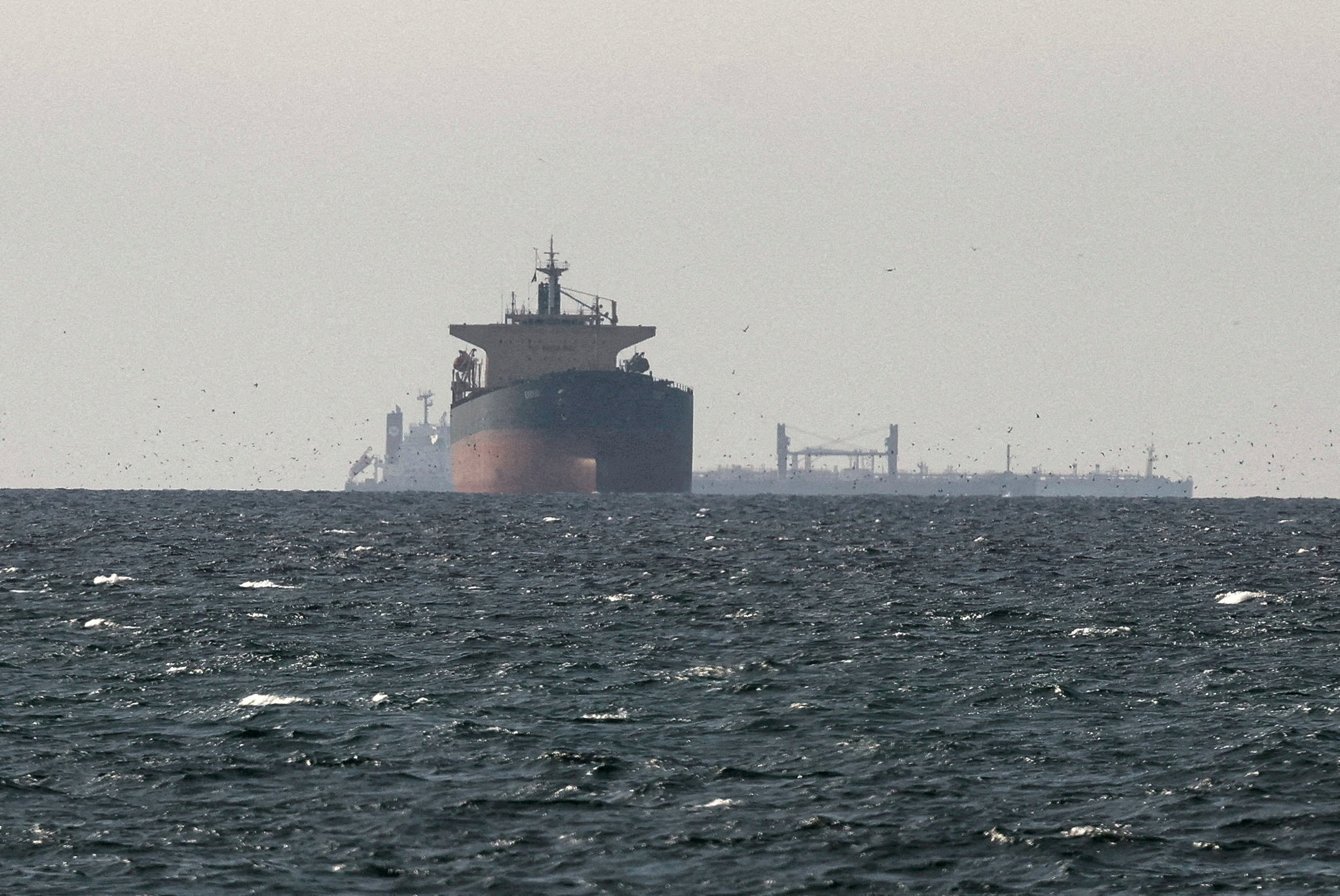 FILE PHOTO: FILE PHOTO: Cargo ships in the Gulf, near the Strait of Hormuz, as seen from northern Ras al-Khaimah, near the border with Oman’s Musandam governance, amid the U.S.-Israeli conflict with Iran, in United Arab Emirates, March 11, 2026. REUTERS/Stringer/File Photo