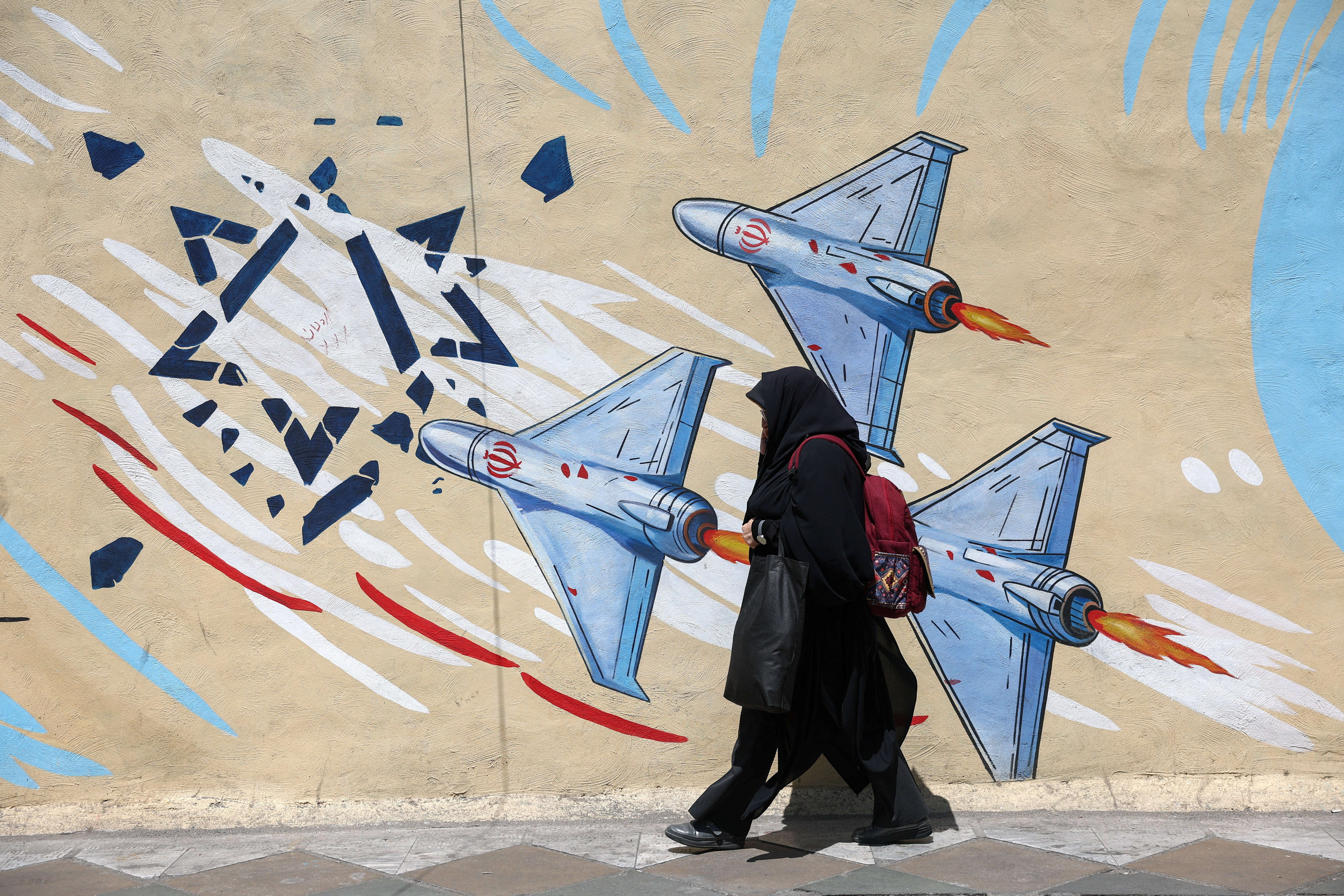 An Iranian woman walks past an anti-Israeli mural in Tehran, Iran, June 28, 2026. Majid Asgaripour/WANA (West Asia News Agency) via REUTERS ATTENTION EDITORS - THIS PICTURE WAS PROVIDED BY A THIRD PARTY. ATTENTION EDITORS - THIS PICTURE WAS PROVIDED BY A THIRD PARTY. ISRAEL OUT. NO COMMERCIAL OR EDITORIAL SALES IN ISRAEL. NO ACCESS FOR ISRAELI MEDIA. NO USE BBC PERSIAN. NO USE VOA PERSIAN. NO USE MANOTO. NO USE IRAN INTERNATIONAL. NO USE RADIO FARDA. DIGITAL: NO USE BBC PERSIAN. NO USE VOA PERSIAN. NO USE MANOTO. NO USE IRAN INTERNATIONAL. NO USE RADIO FARDA.