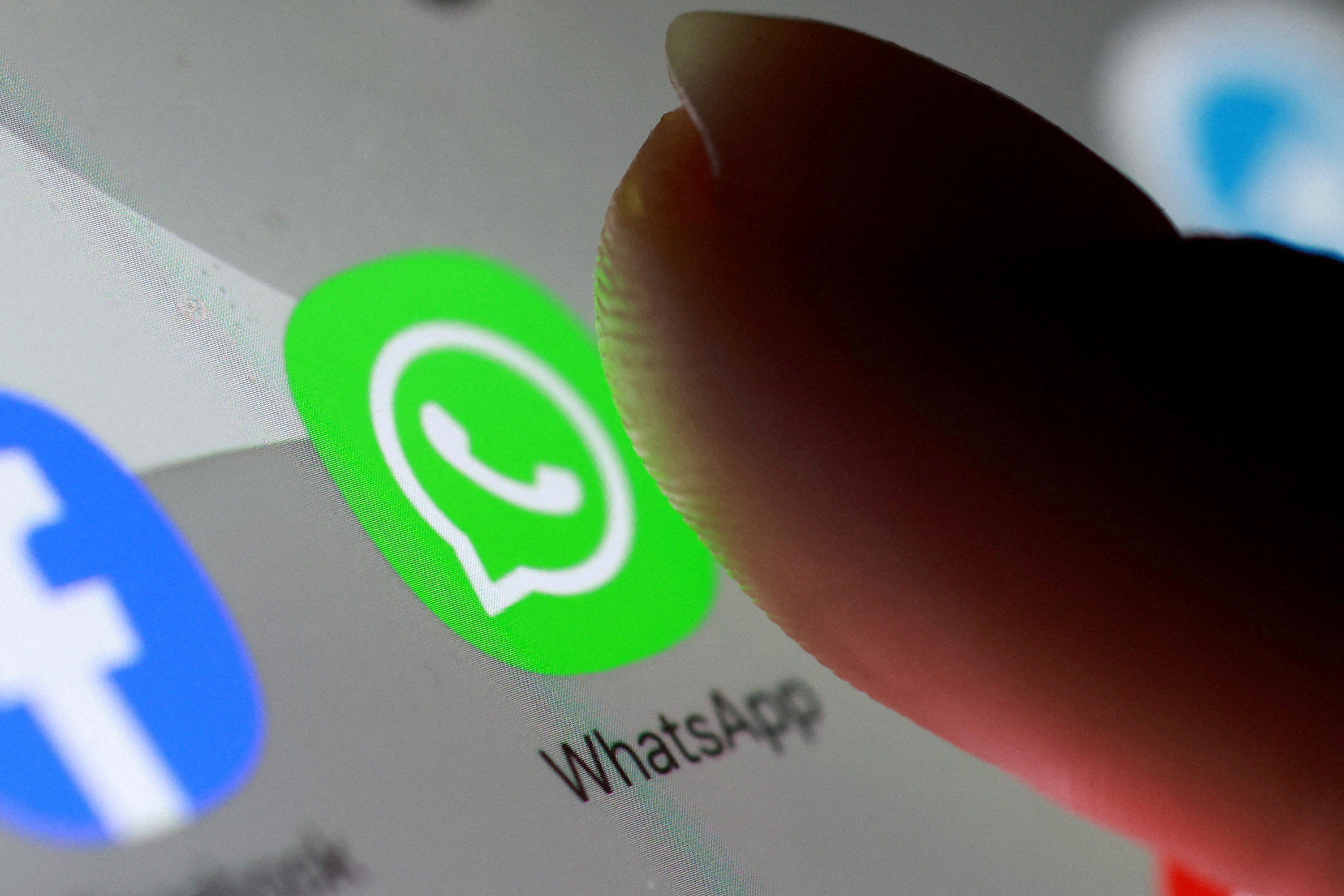The WhatsApp app icon is seen on a smartphone.
