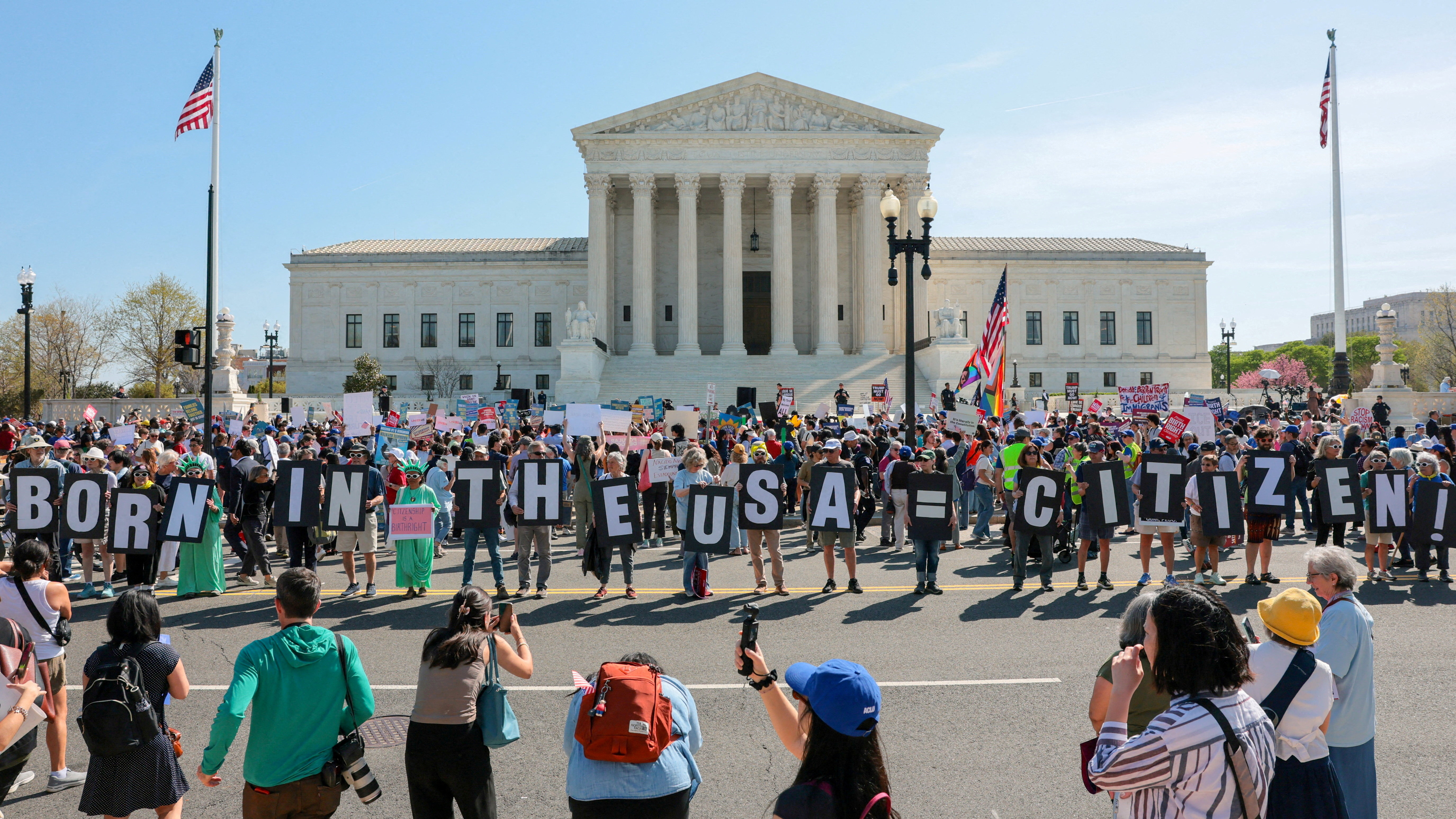 Demonstrators hold letters making up the slogan "Born in the USA = citizen!" outside the US Supreme Court building.