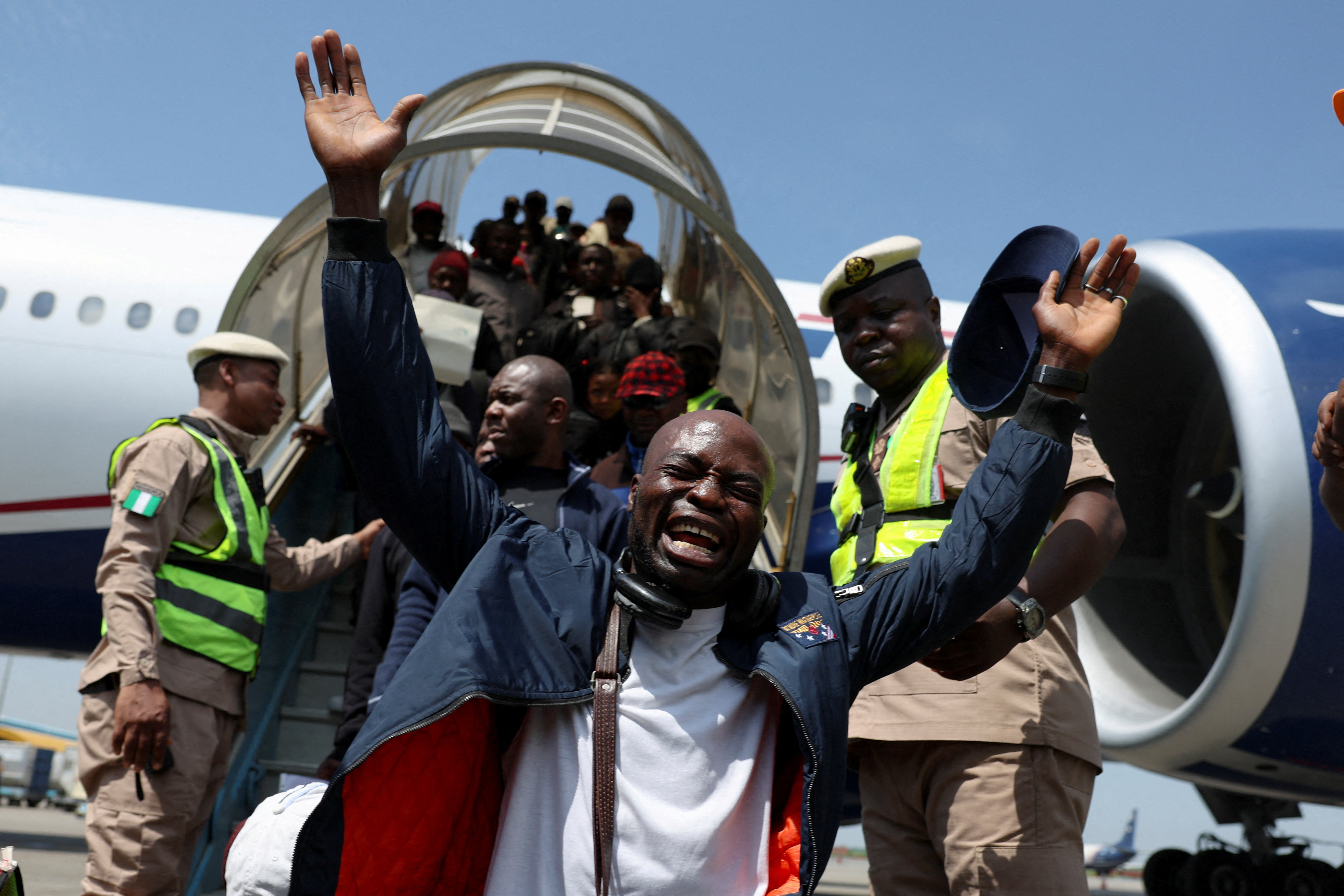 A man reacts after disembarking from an aircraft, as authorities repatriate citizens fleeing xenophobic attacks in South Africa, at Murtala Muhammed International Airport in Lagos, Nigeria, June 11, 2026.
