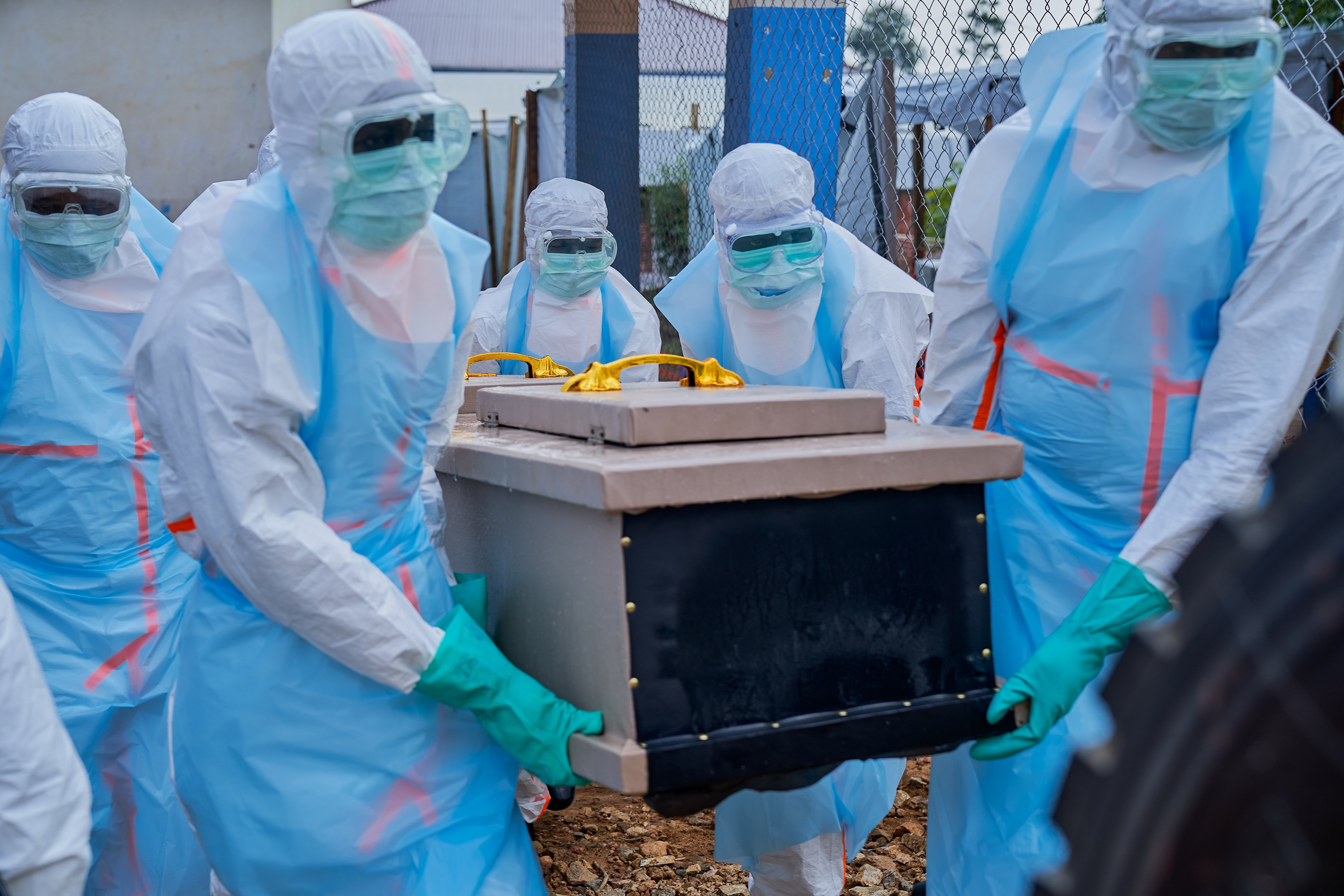 Staff lift a coffin into a vehicle at the Ebola treatment center of the General Hospital in Bunia, Ituri province, Democratic Republic of Congo