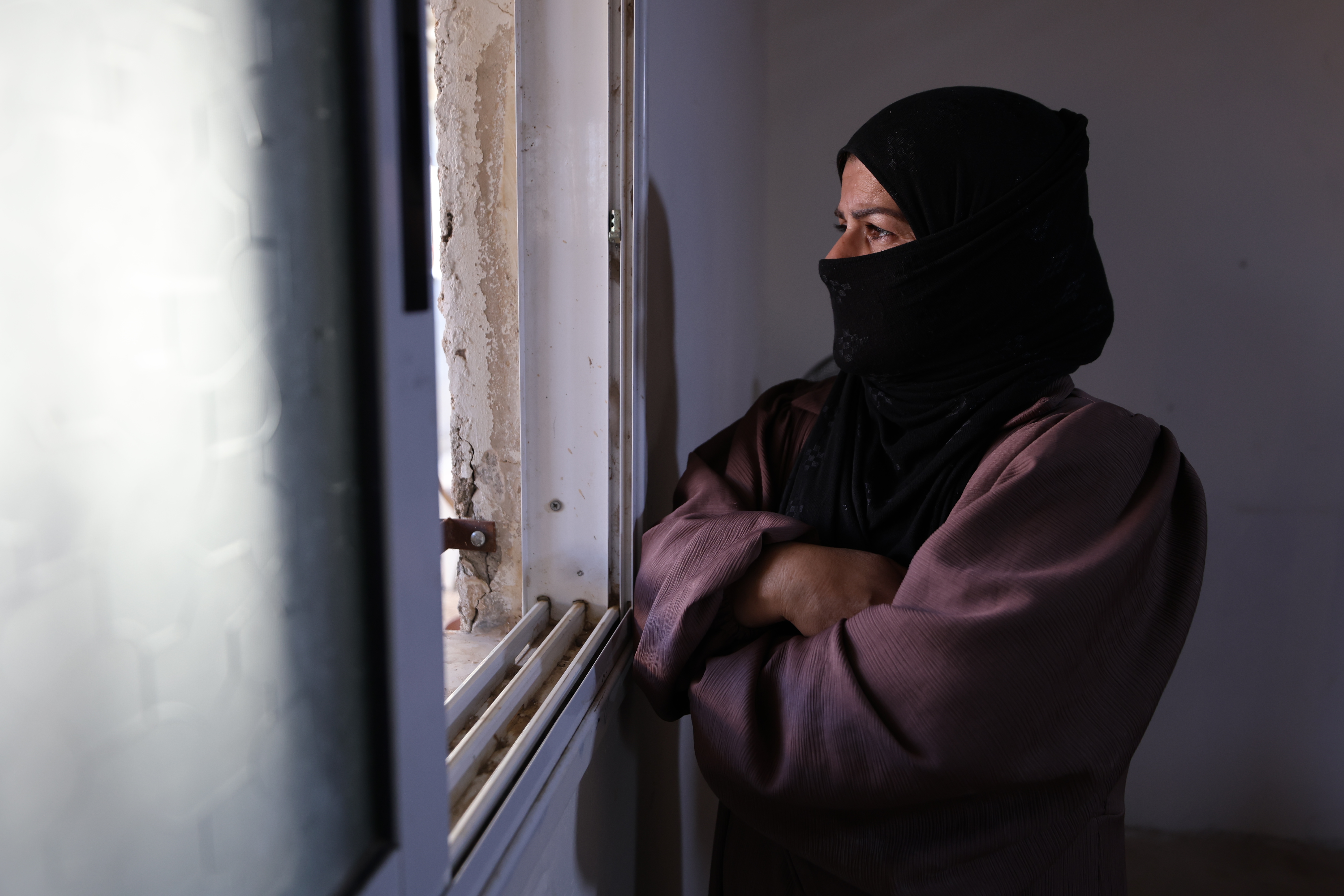 Ikhlas al-Hathaleen looks out of the window