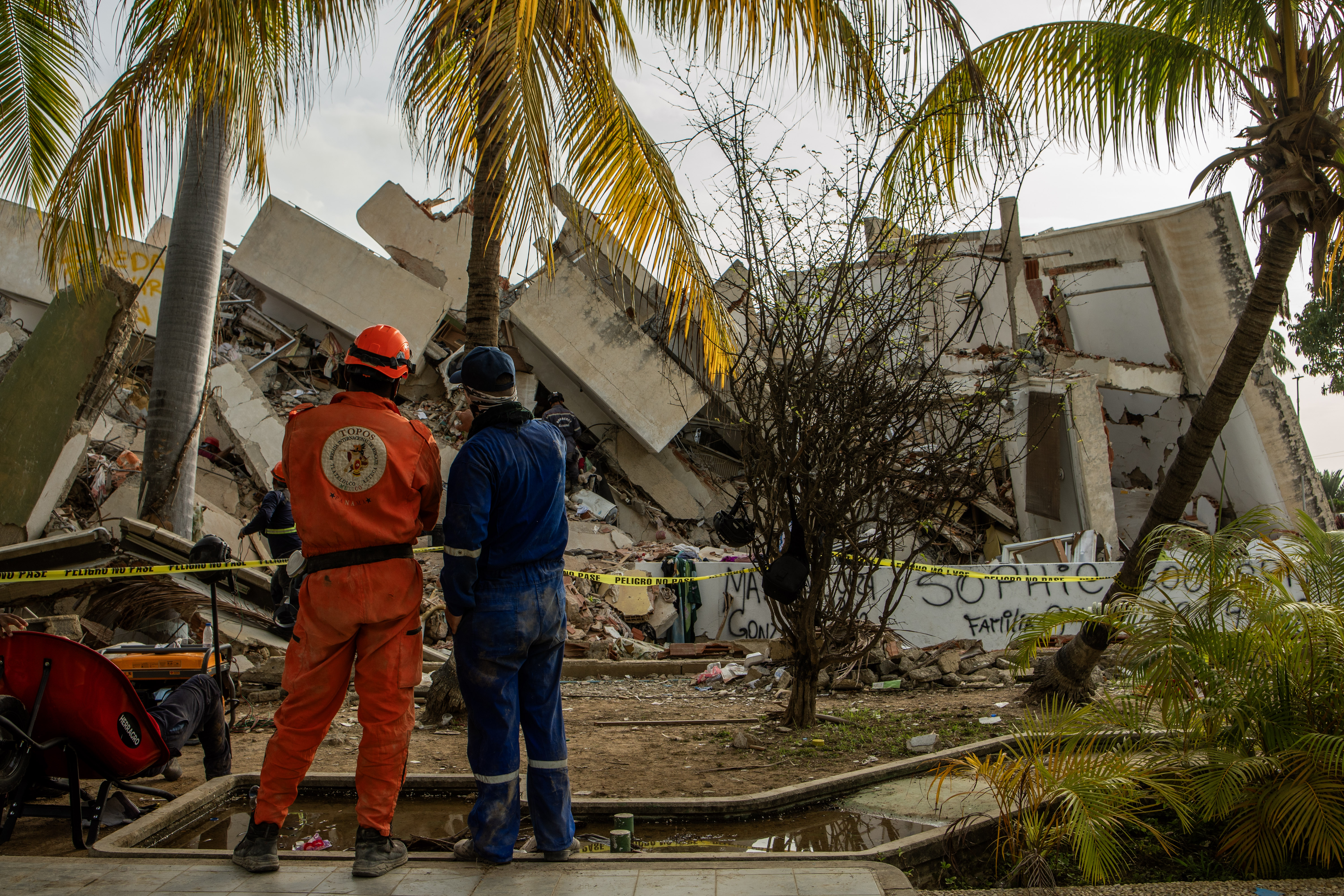 International rescue teams assess a collapsed building site in La Guaira