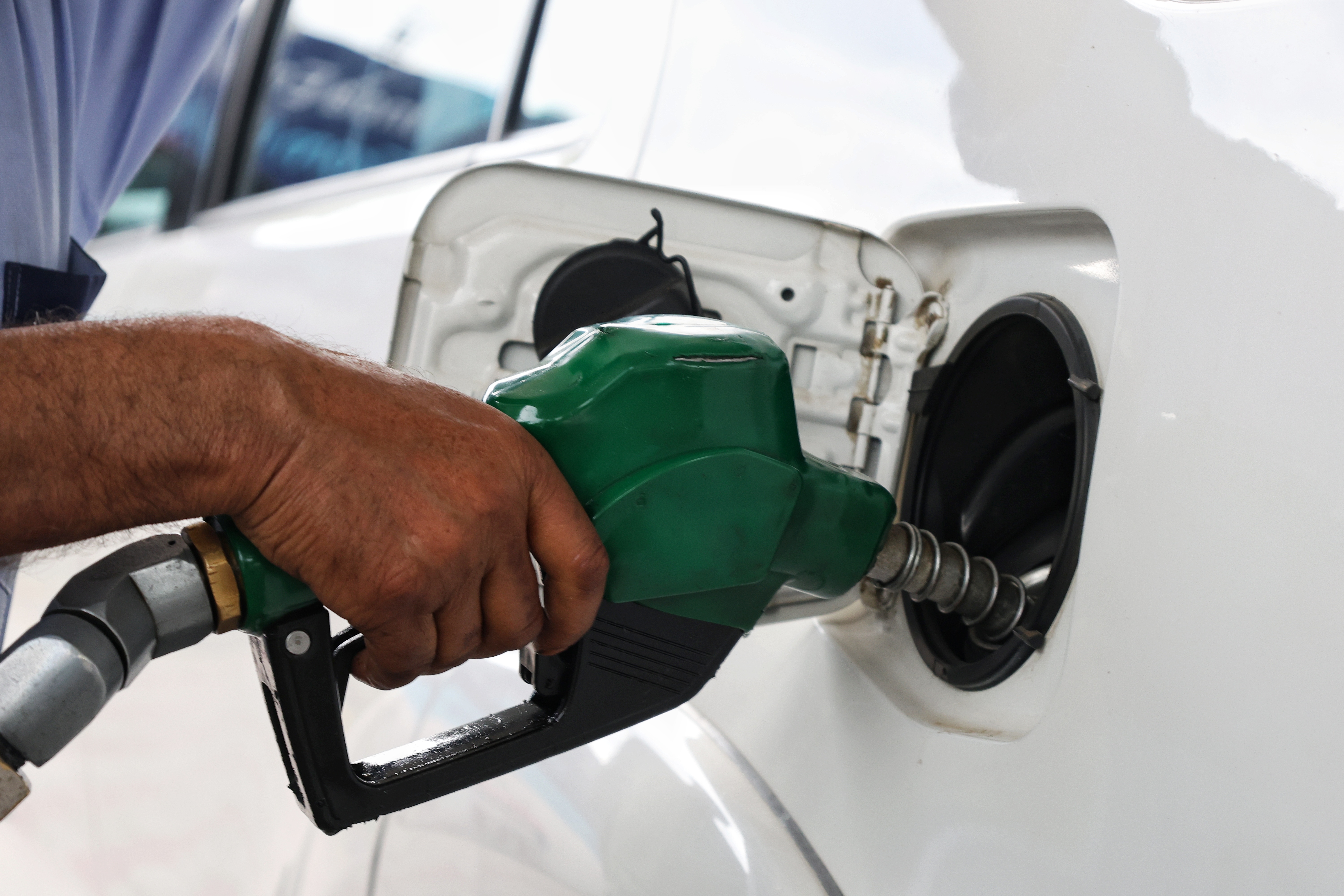 A fuel attendant fills a petrol car at a fuel station in Srinagar, Indian-administered Kashmir, after the introduction of E20 petrol in the region [Numan Bhat/ Al Jazeera]