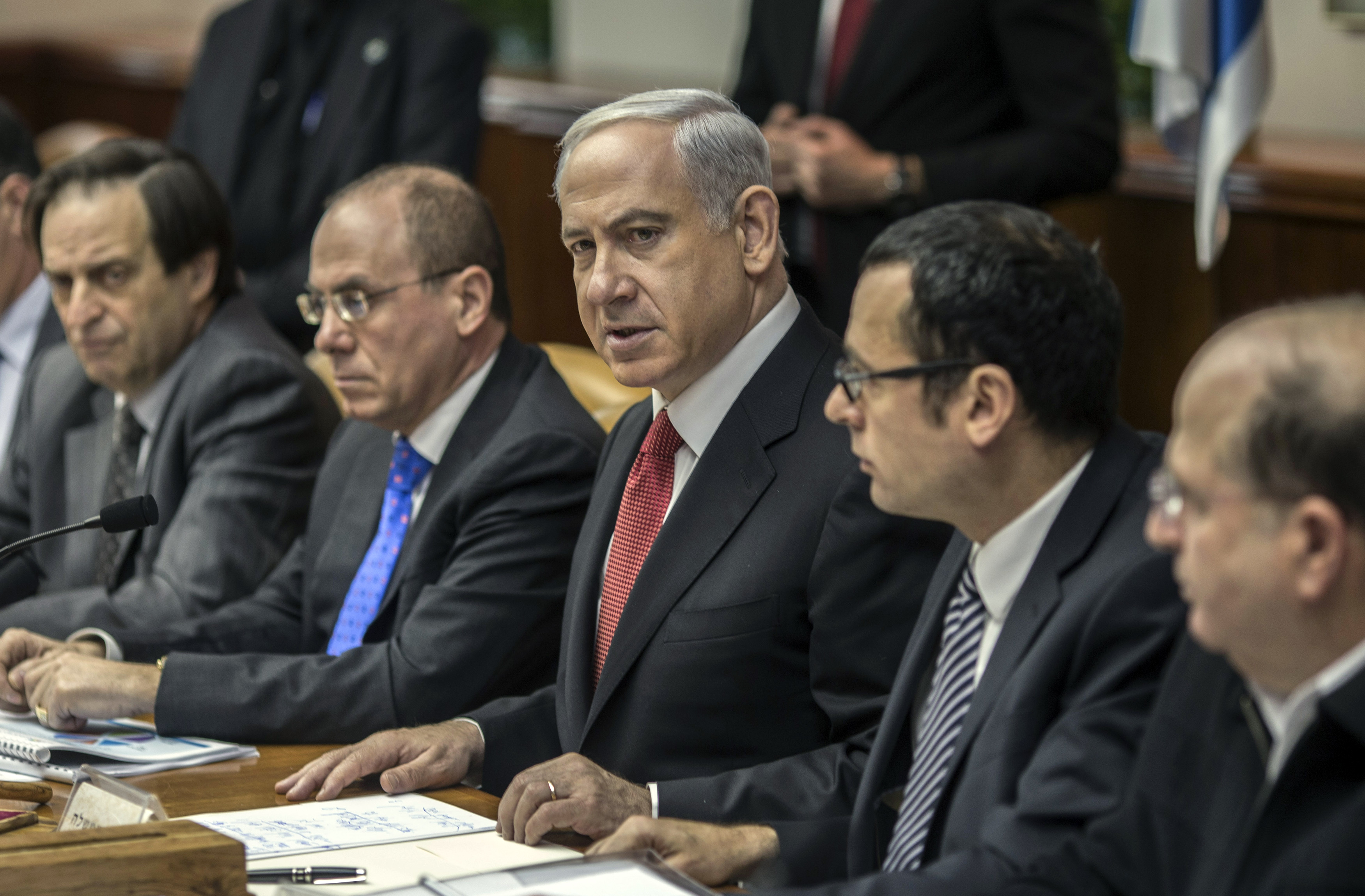 Israel's Prime Minister Benjamin Netanyahu (C) attends the weekly cabinet meeting in Jerusalem February 3, 2013. Netanyahu on Saturday took on the job of forming a new government and said its most important task would be to ensure that Iran does not gain nuclear arms. REUTERS/Oliver Weiken/Pool