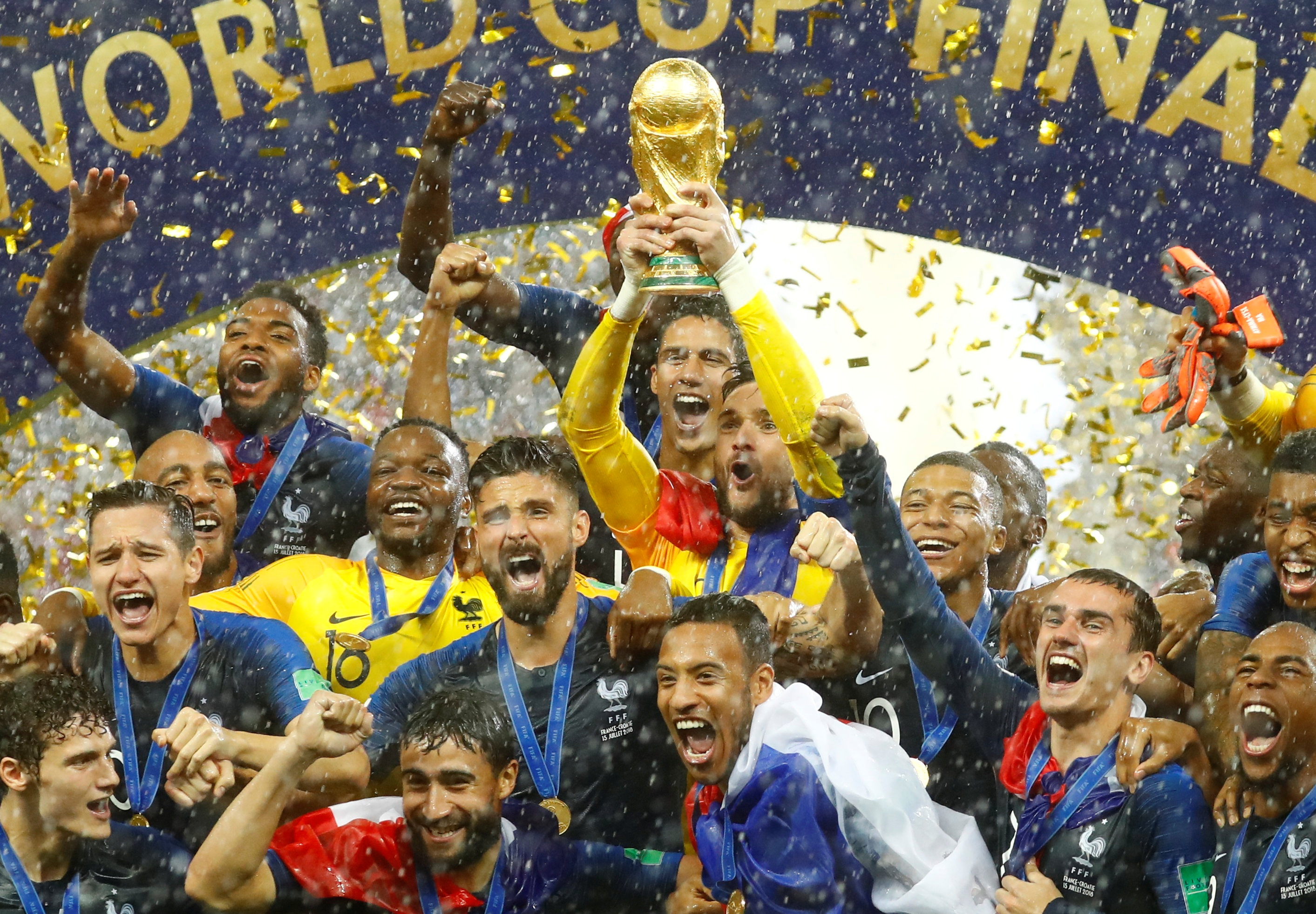 FranceÕs Hugo Lloris lifts the trophy as they celebrate after winning the World Cup