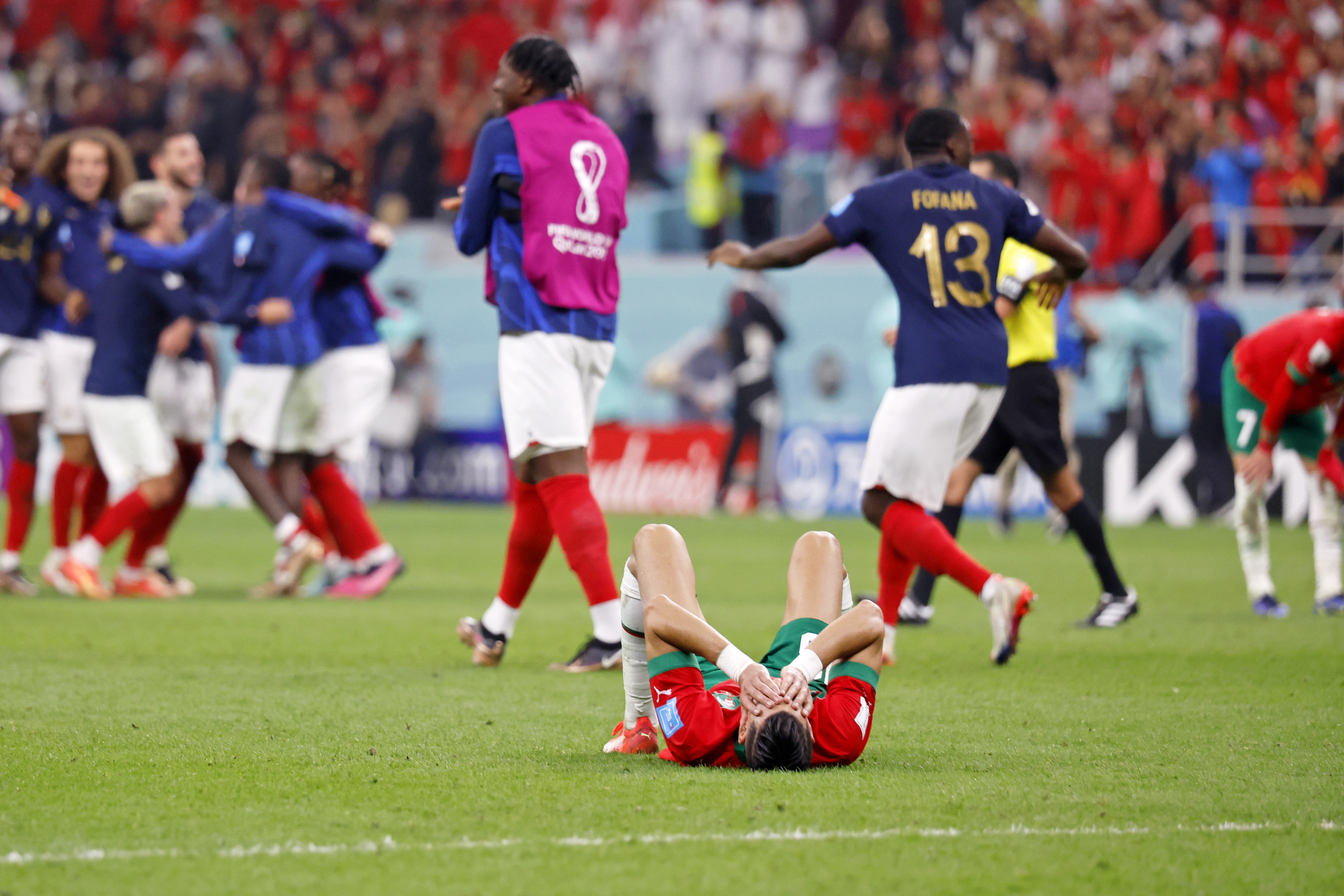 Morocco defender Jawad El Yamiq is down on the pitch after losing a semifinal against France in the 2022 World Cup in Qatar