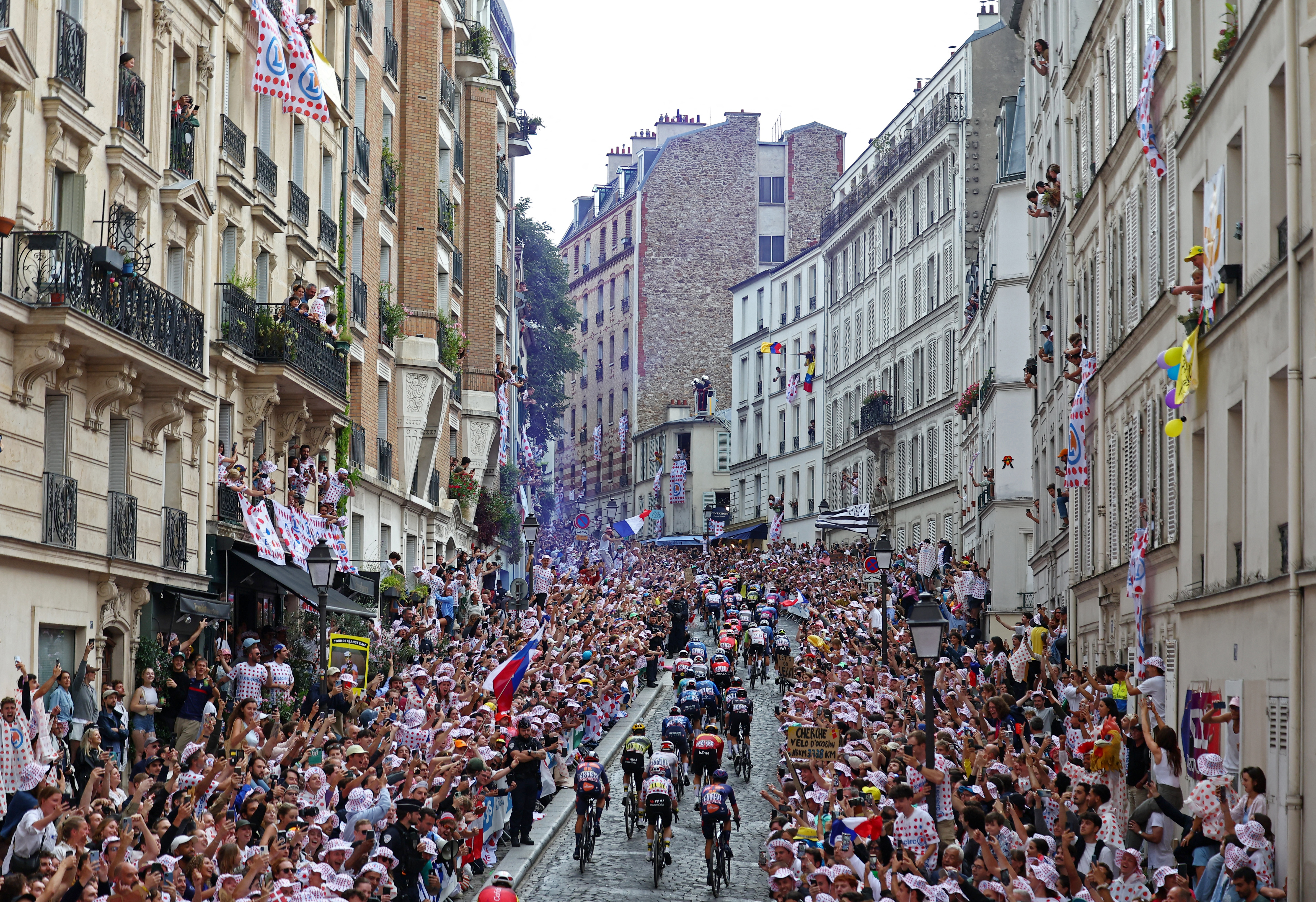 riders in action as they climb the Cote de la Butte Montmartre during Stage 21