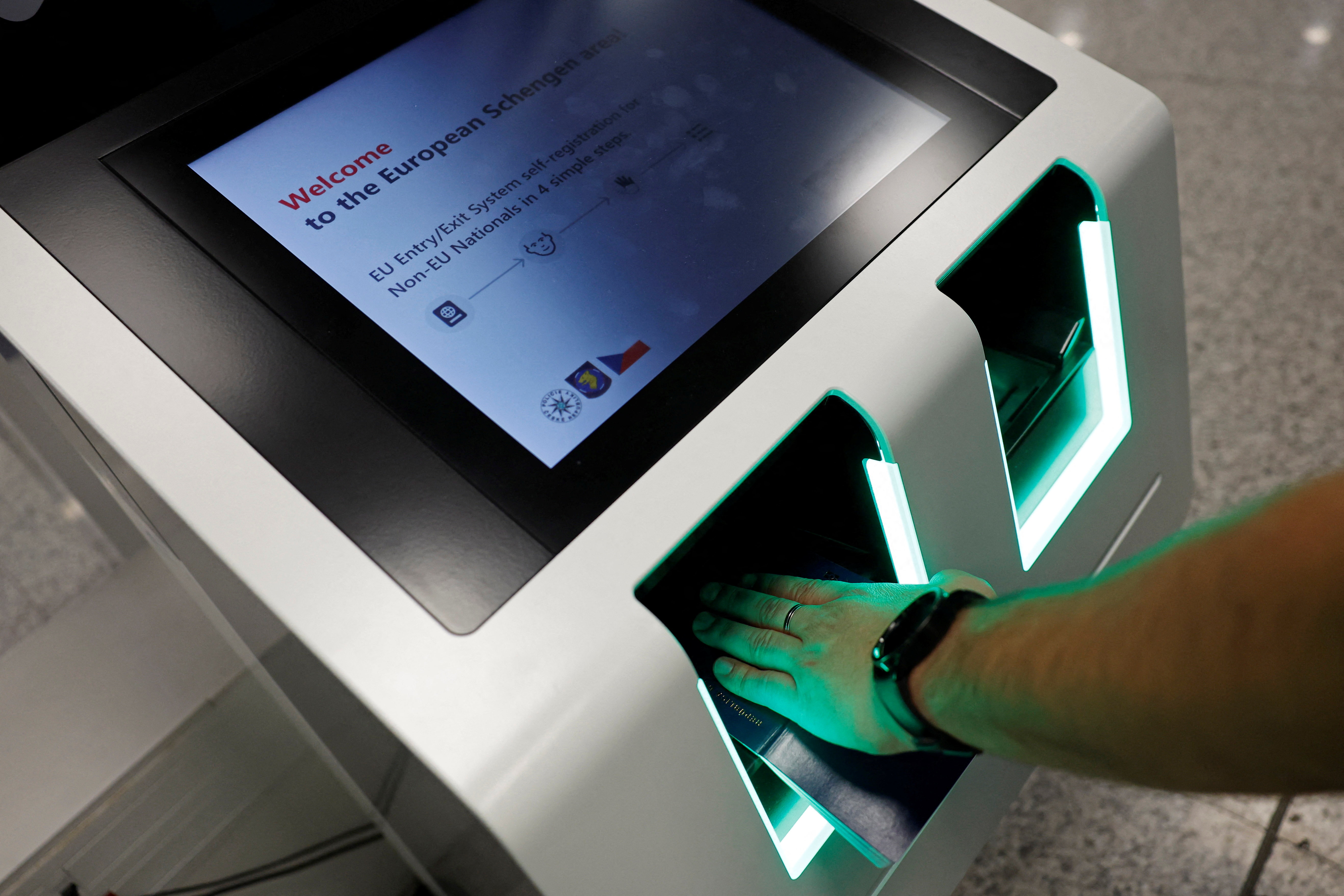 A police officer scans a passport during a presentation of an automated terminal for registration to the Entry/Exit System (EES) at the Vaclav Havel airport in Prague, Czech Republic, on October 14, 2025