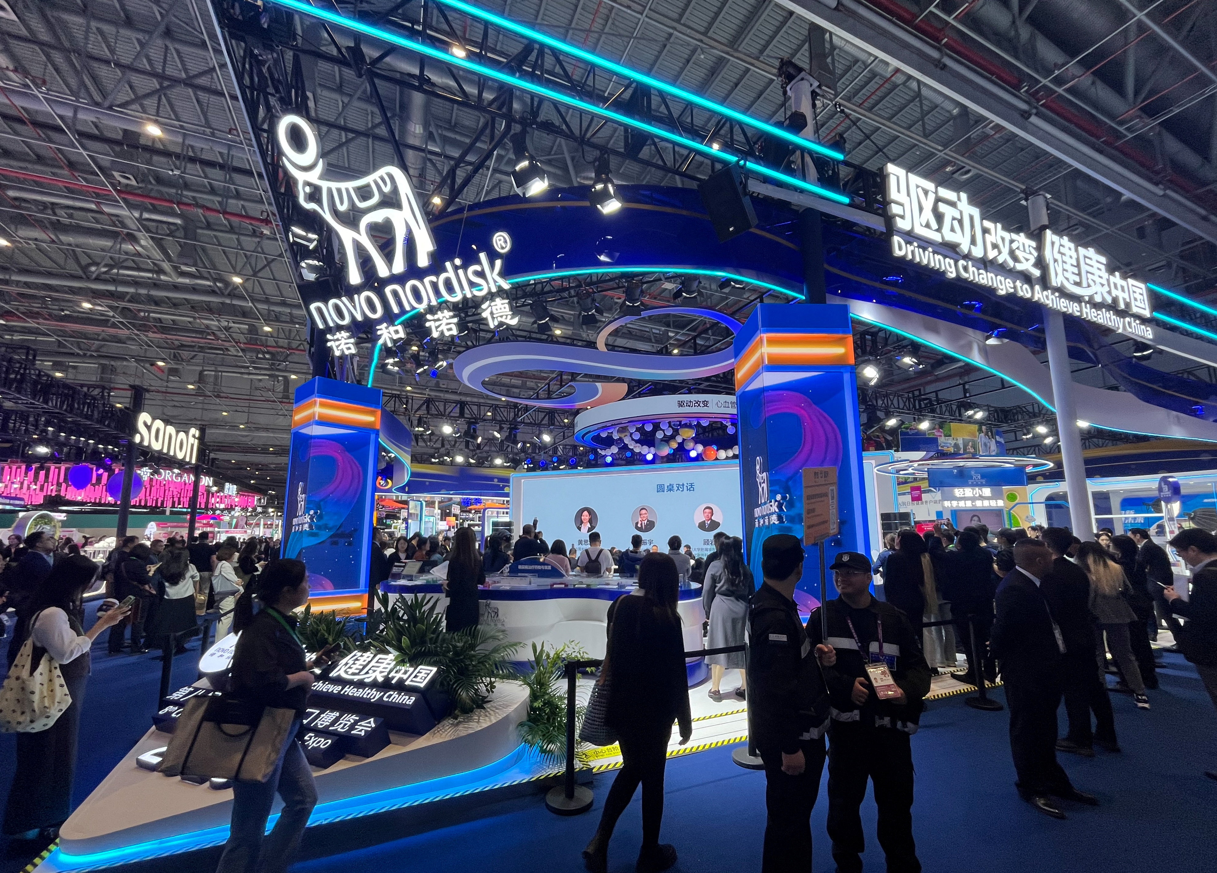 People walk past the Novo Nordisk booth at the 8th China International Import Expo (CIIE) in Shanghai, China November 6, 2025. REUTERS/Andrew Silver