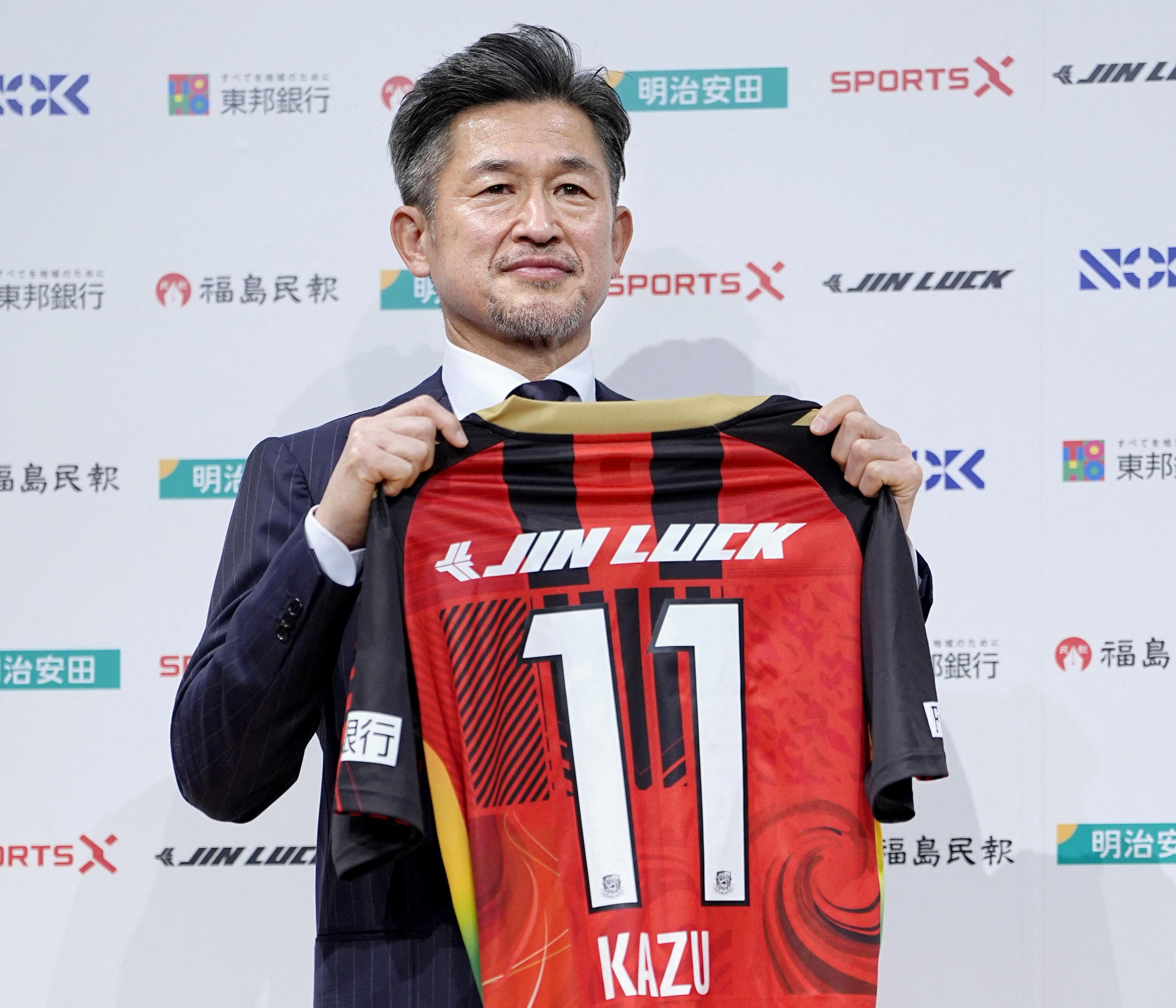 Kazuyoshi Miura poses for a photograph during his first news conference after joining Fukushima United