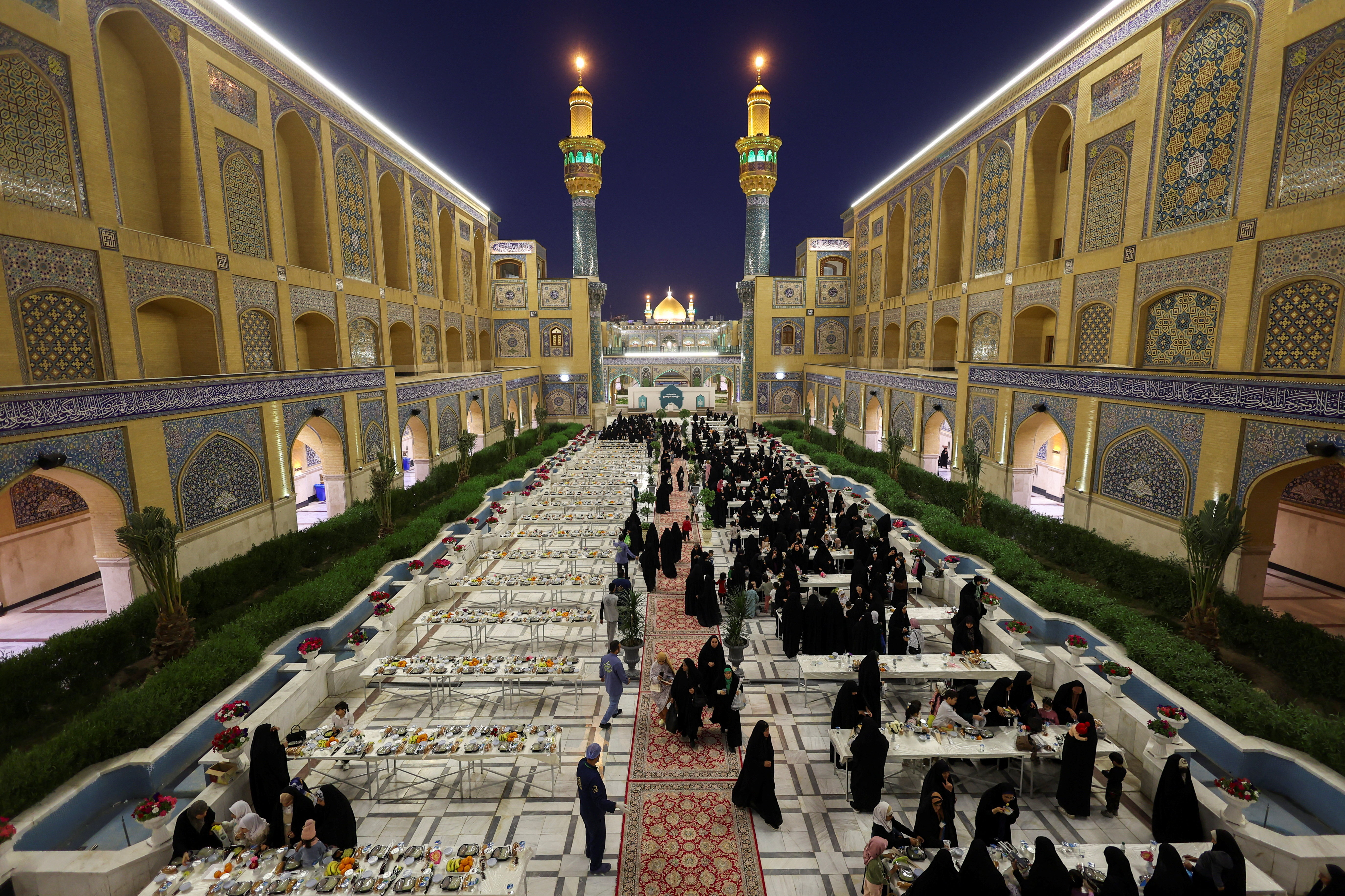 Worshippers gather for a free public iftar at the courtyard of the Imam Ali Shrine during the holy month of Ramadan, in Najaf, Iraq, on February 20, 2026