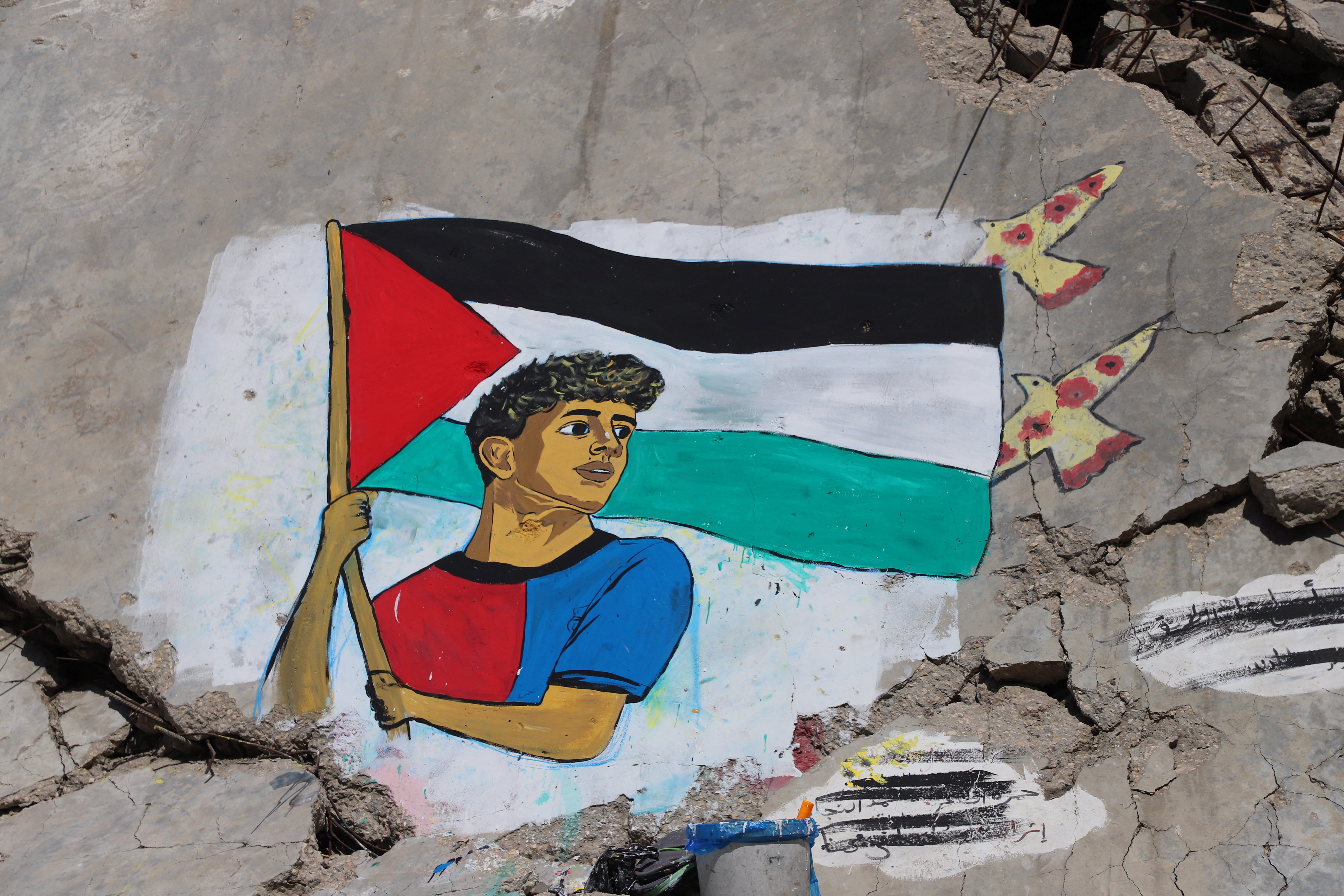 A mural painted by Palestinian artists depicts soccer star Lamine Yamal, who waved a Palestinian flag during Barcelona's LaLiga victory parade, on the rubble of buildings destroyed during the war, at Shati (Beach) refugee camp in Gaza City, May 13, 2026. REUTERS/Ebrahim Hajjaj