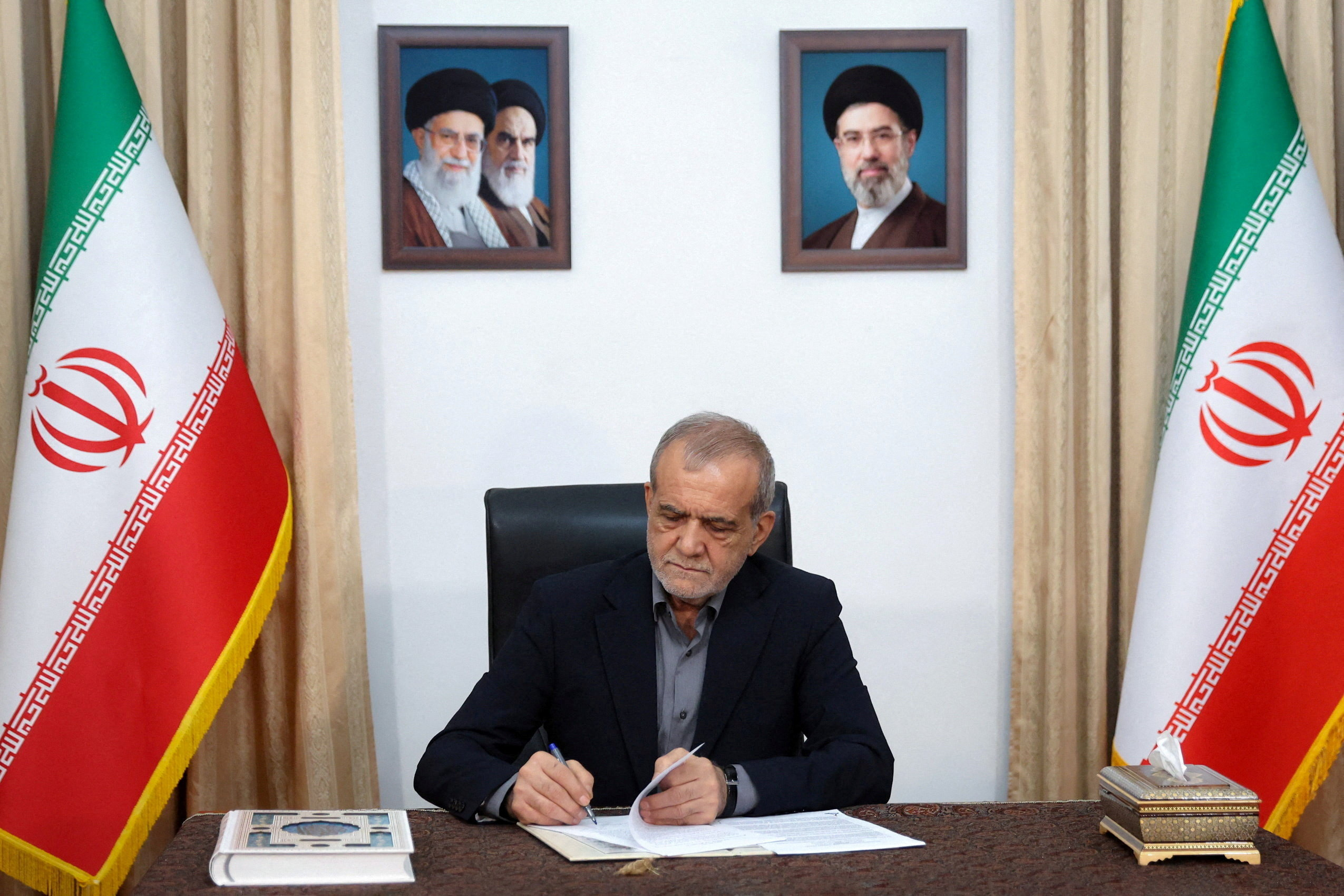 Iranian President Masoud Pezeshkian signs the document of U.S. Memorandum of Understanding in Tehran, Iran, June 18, 2026. Iran's Presidential website/WANA (West Asia News Agency)/Handout via REUTERS ATTENTION EDITORS - THIS PICTURE WAS PROVIDED BY A THIRD PARTY. ISRAEL OUT. NO COMMERCIAL OR EDITORIAL SALES IN ISRAEL. NO ACCESS FOR ISRAELI MEDIA. NO USE BBC PERSIAN. NO USE VOA PERSIAN. NO USE MANOTO. NO USE IRAN INTERNATIONAL. NO USE RADIO FARDA. DIGITAL: NO USE BBC PERSIAN. NO USE VOA PERSIAN. NO USE MANOTO. NO USE IRAN INTERNATIONAL. NO USE RADIO FARDA. TPX IMAGES OF THE DAY