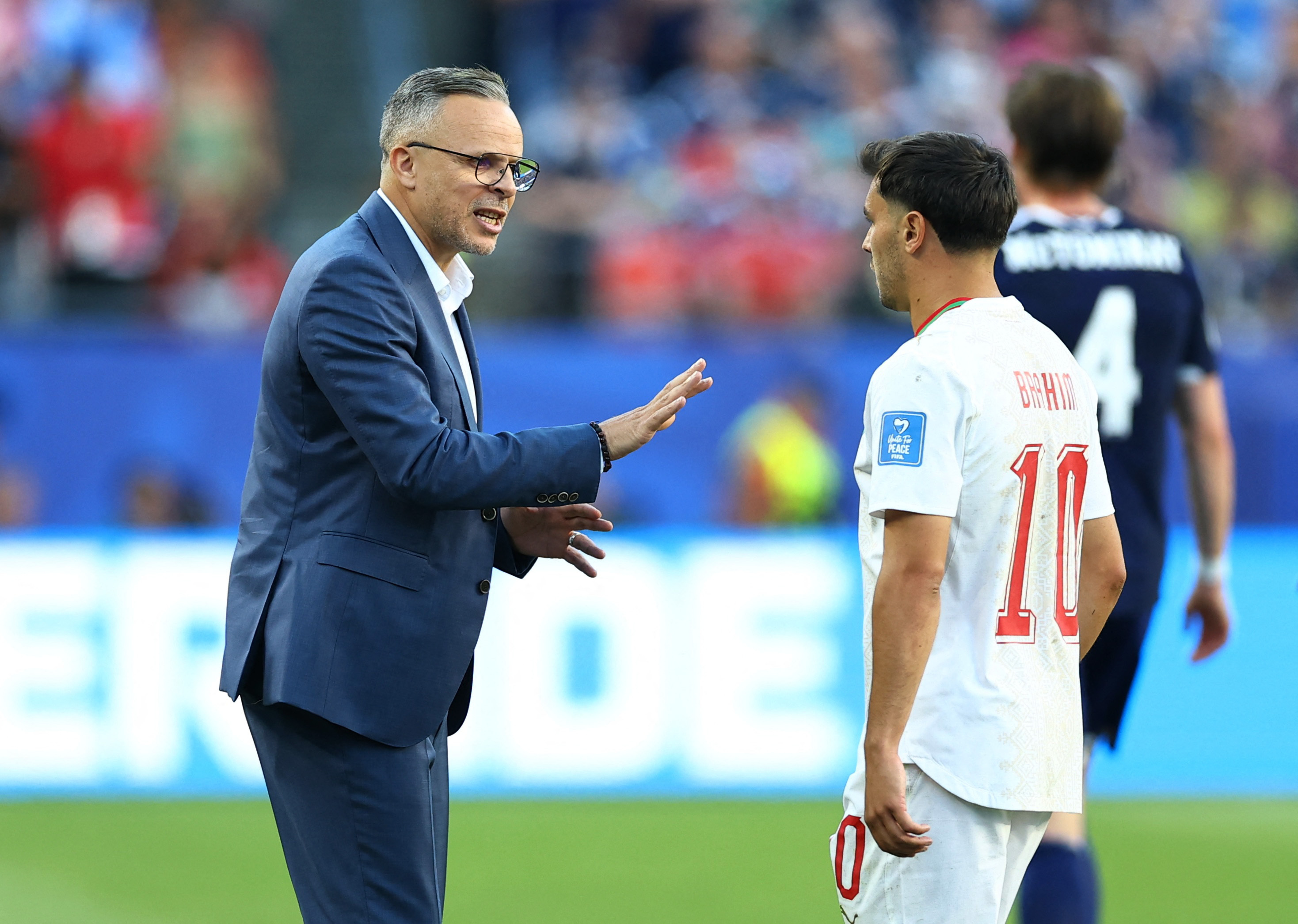 Morocco head coach Mohamed Ouahbi, left, speaks to star player Brahim Diaz during a World Cup match at Boston Stadium