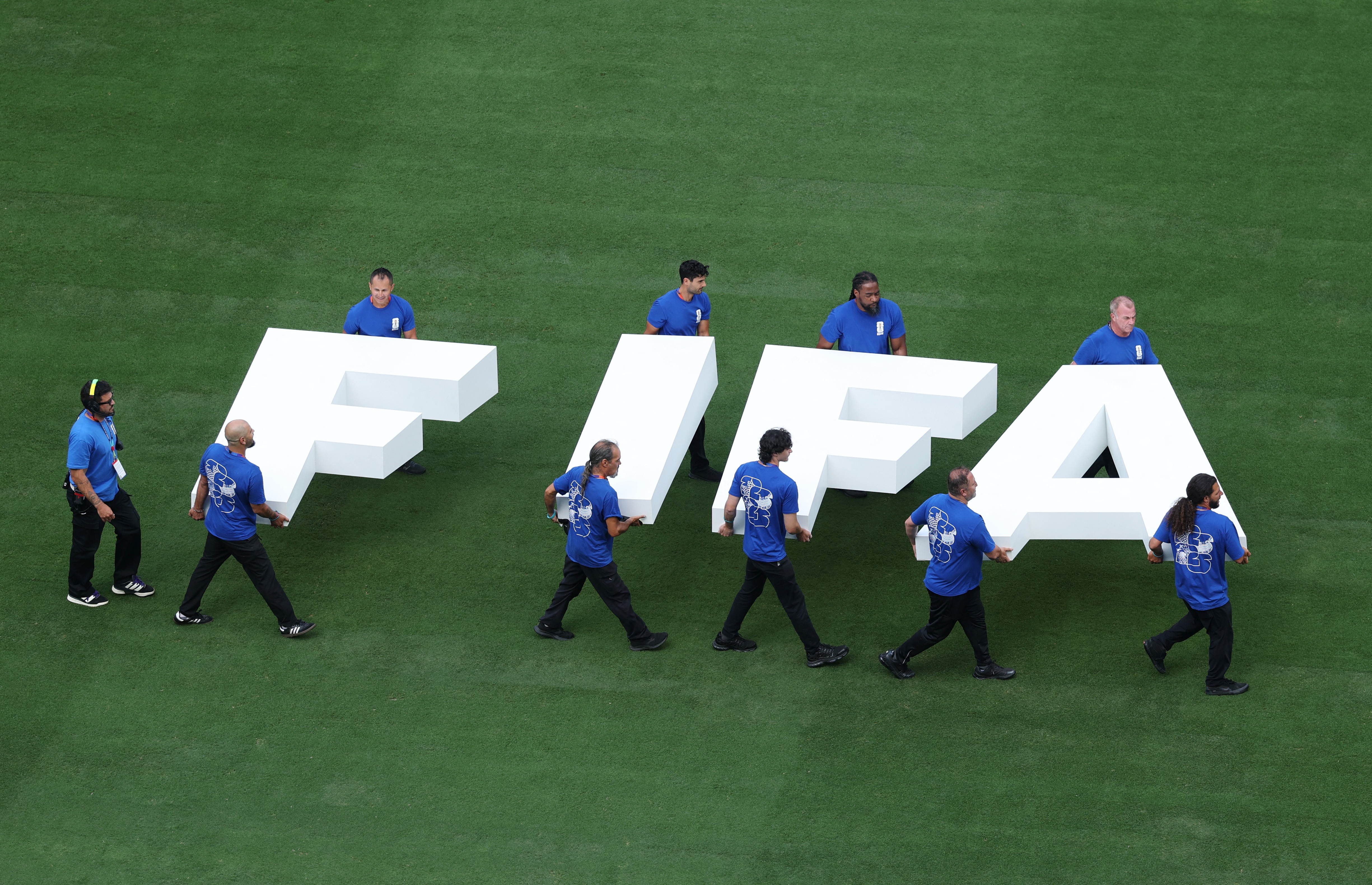 Soccer Football - FIFA World Cup 2026 - Group E - Ecuador v Germany - New York/New Jersey Stadium, East Rutherford, New Jersey, U.S. - June 25, 2026 General view as workers carry the FIFA logo on the pitch before the match REUTERS/John Sibley