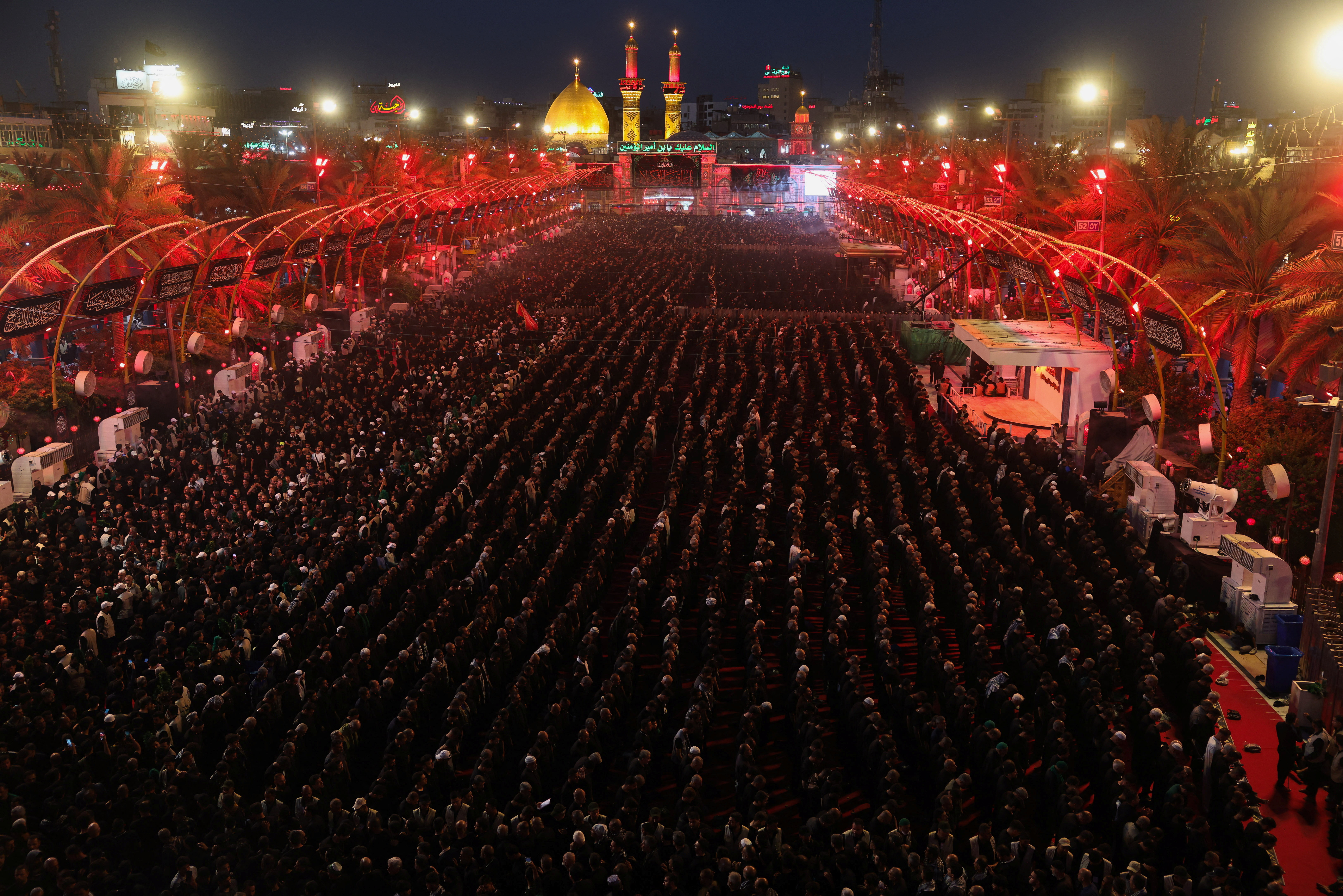 Worshippers perform the Maghrib prayer between the shrines of Imam Hussein and Imam Abbas ahead of Ashura, one of the holiest days on the Muslim calendar, in Karbala, Iraq, on June 25, 2026
