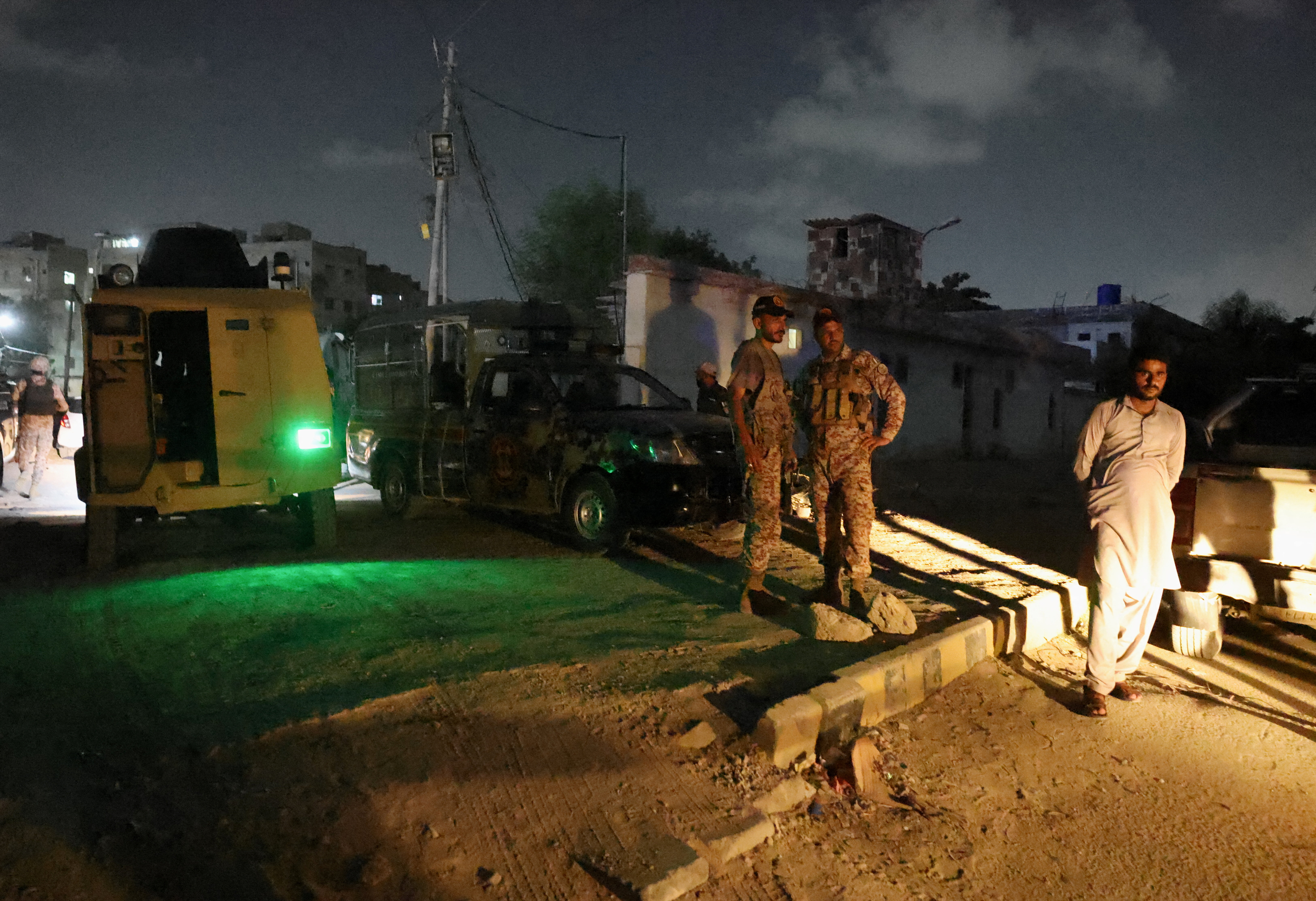 Security personnel stand guard after an explosion and gunfire were reported, near offices of the Rangers, a paramilitary force, in Karachi, Pakistan, June 27, 2026. REUTERS/Akhtar Soomro