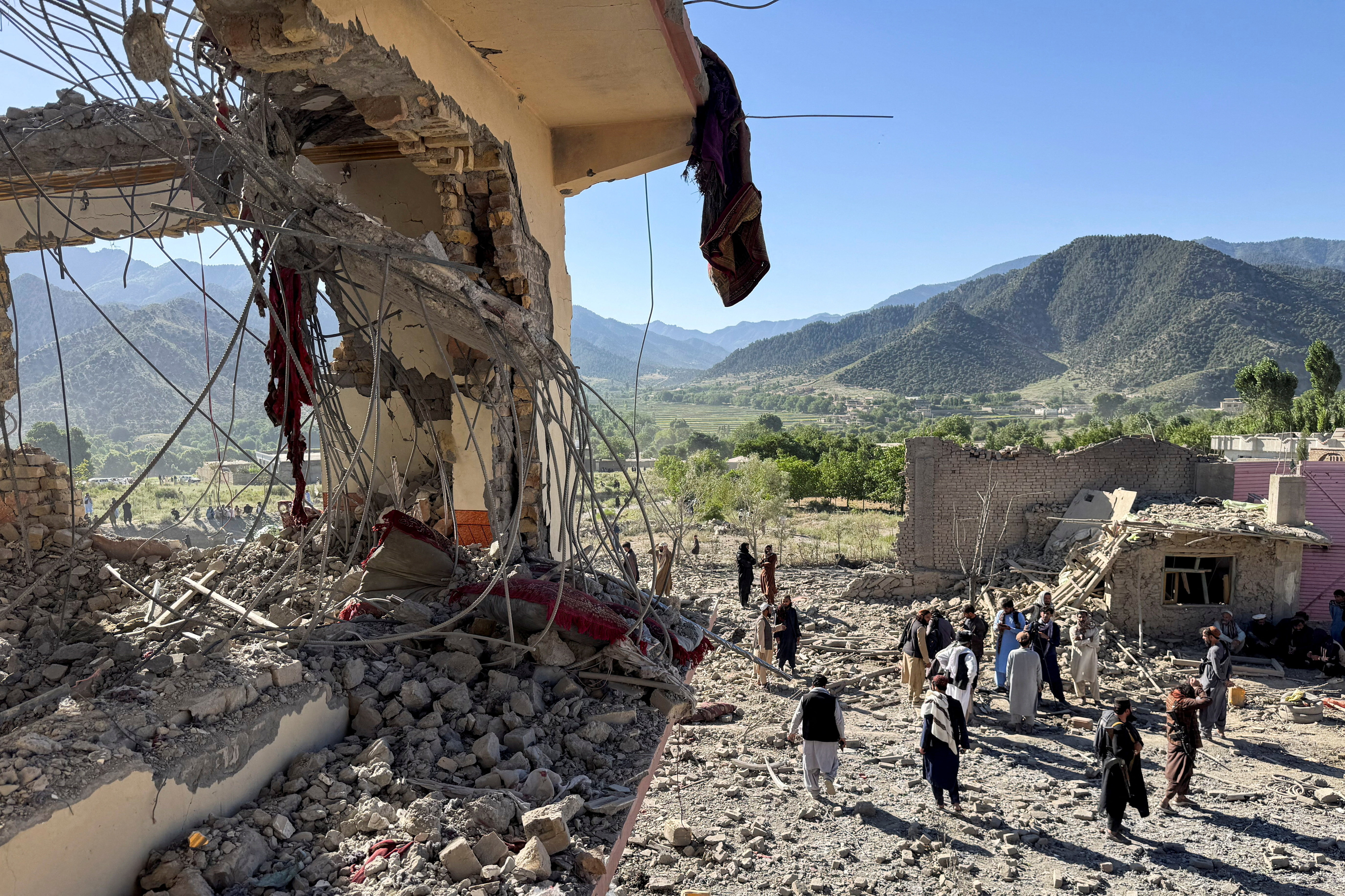 People gather near a destroyed building after an attack, which the Taliban say was an airstrike carried out by Pakistan's security forces, in Samkani District, Paktia Province, Afghanistan, June 29, 2026. REUTERS/Stringer