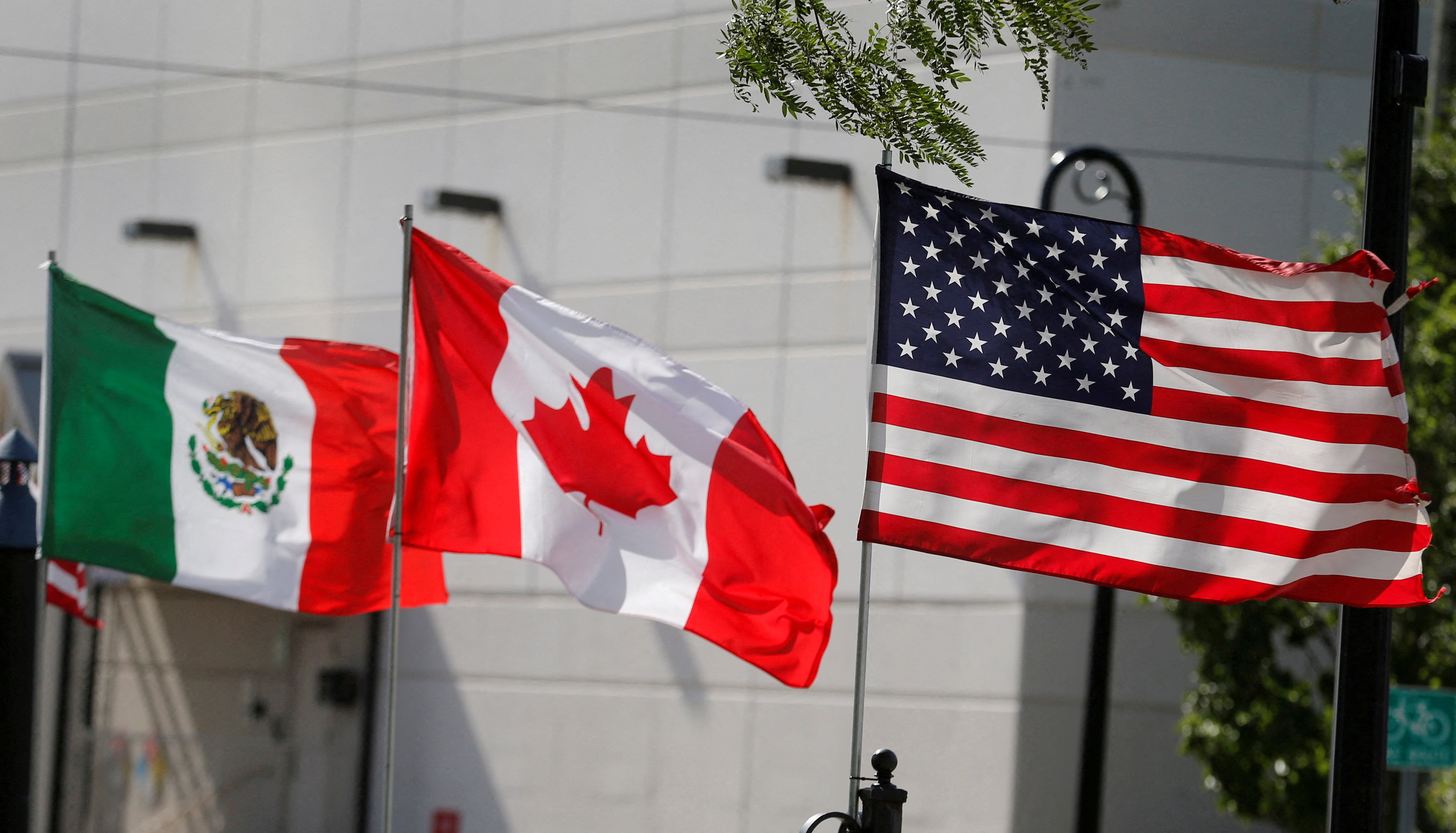 Flags of the U.S., Canada and Mexico fly next to each other [FILE: Rebecca Cook/Reuters]