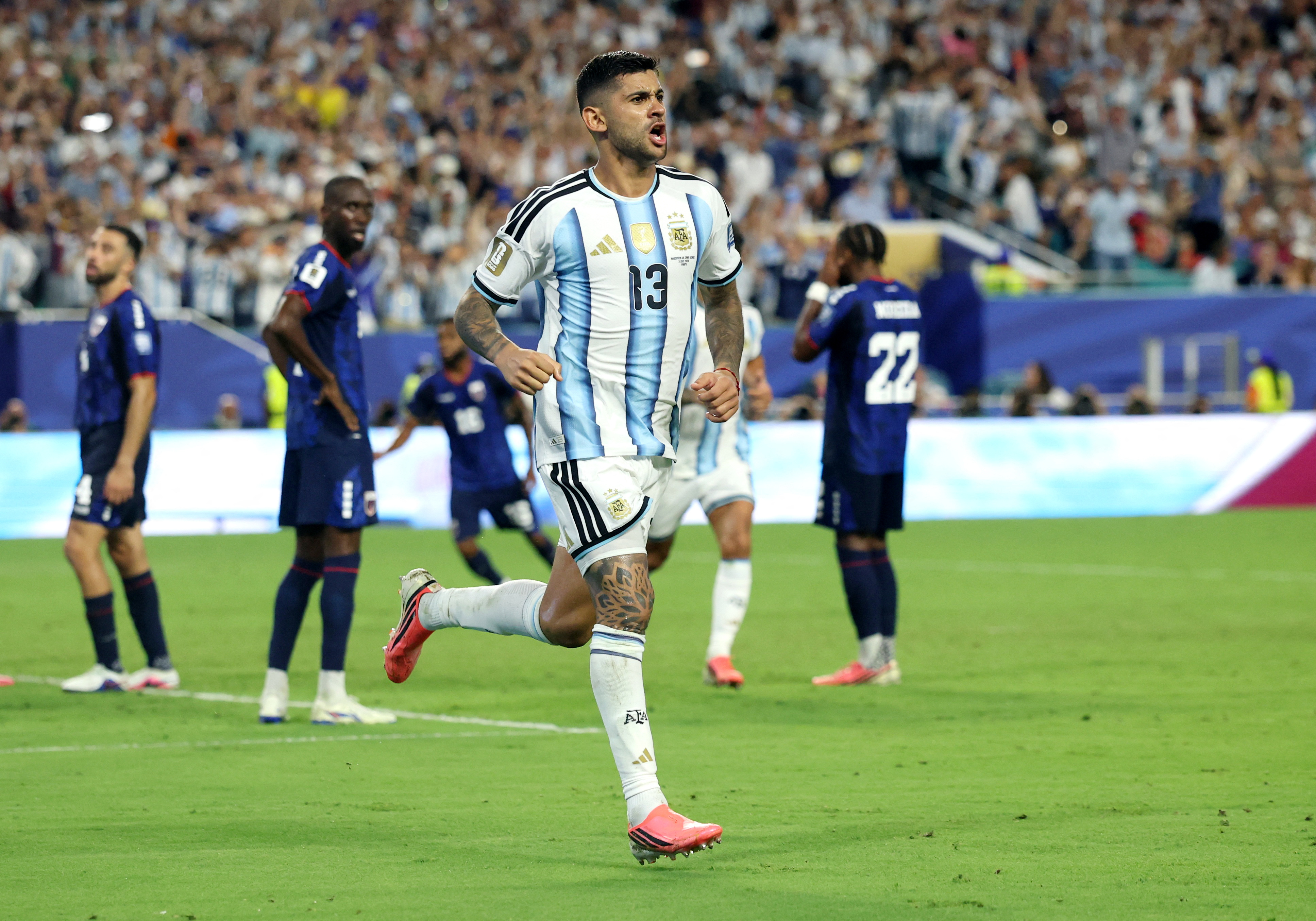 Argentina's Cristian Romero celebrates scoring their third goal